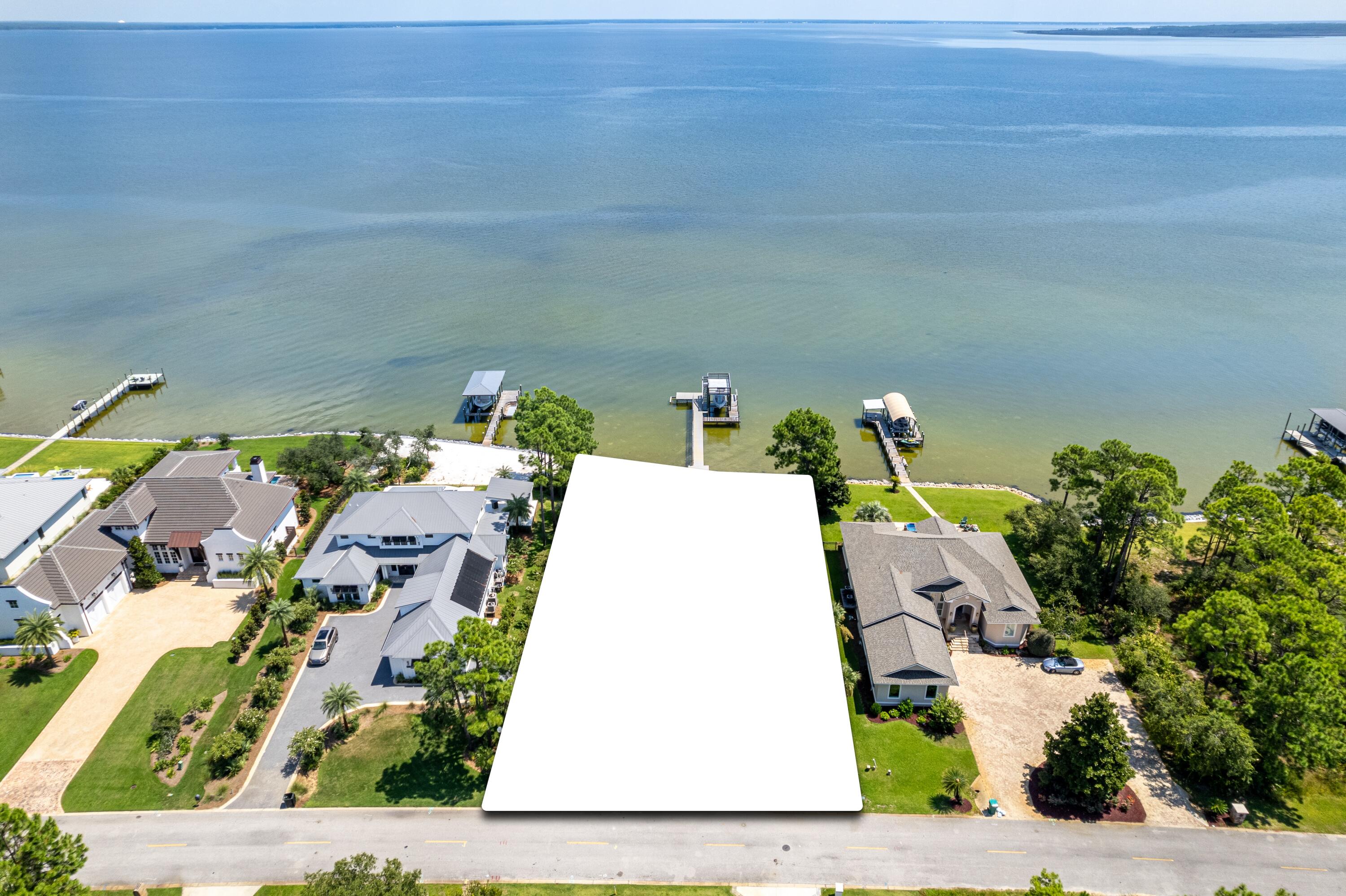 Exceptional opportunity to build a spacious retreat perched on the banks of stunning Choctawhatchee Bay. Home has been destroyed by fire and will need to be removed by the buyer. Total loss presents an incredible opportunity to purchase a rarely available vacant lot on Driftwood Pt Rd., where all eyes lead to the water. Escape to a private Oasis with 100' of bay frontage. Drive down prestigious Driftwood Point, minutes from the Emerald Coast's finest beaches, shopping, dining and entertainment yet world's away from everyday distractions. Boating is easily accessible with the recently reconstructed covered decking with deck featuring flow through decking. 
Low HOA costs, friendly neighbors, and pink hued sunsets. Discover life on the bay!