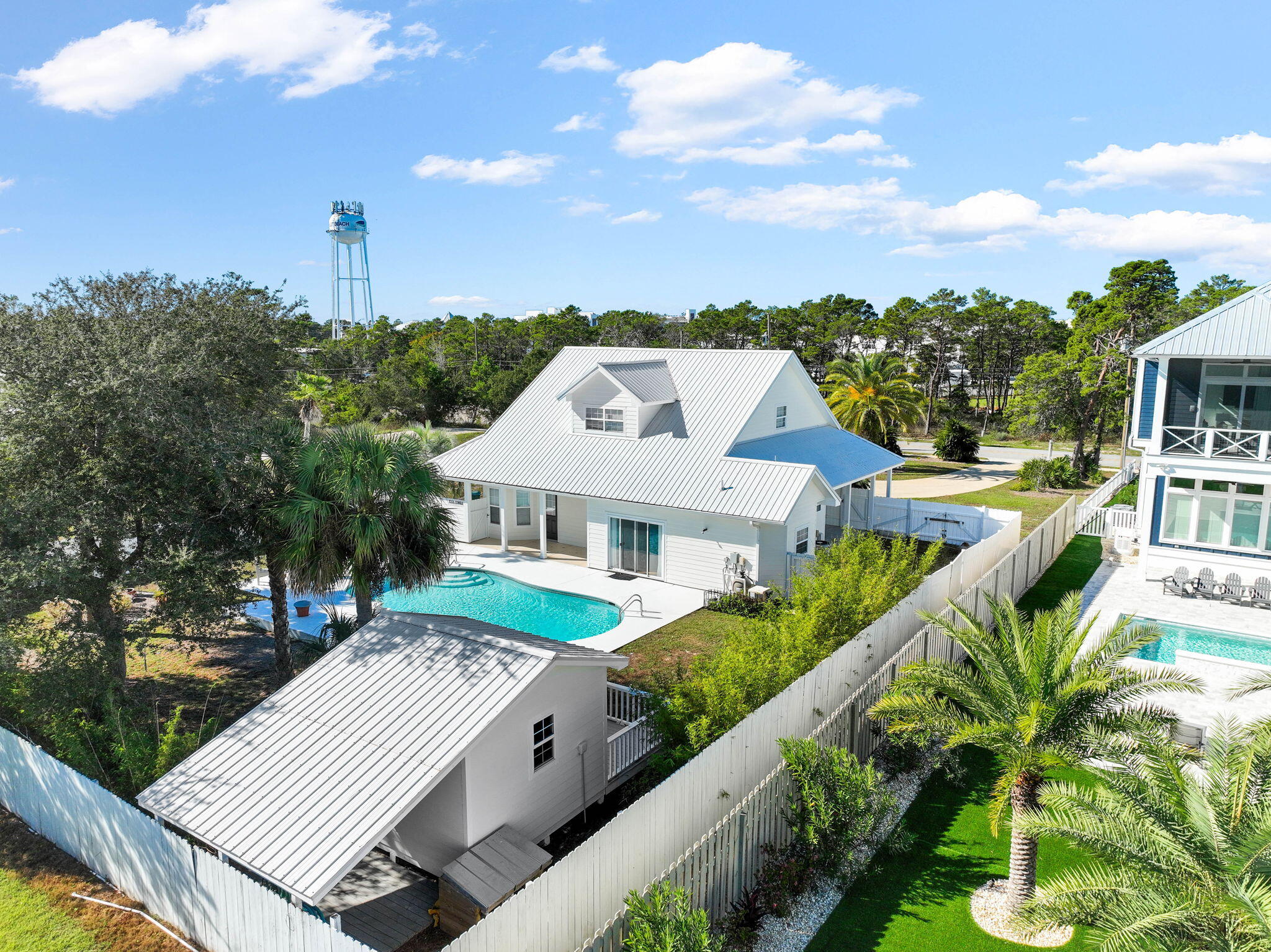 This stylish two-story beach house has been fully renovated inside and out. Sitting on a beautifully landscaped 0.36 lot, this elegant single-family home has dormer windows on the second floor and the added luxury of privacy and space. As well as the private pool, there's ample space to add a garage or carriage house, if desired. A horseshoe-shaped driveway provides ample parking and an attractive approach to the house. Screened by tropical palms, the full-width front porch offers a welcome place to relax and 'smell the roses' at the end of a busy day. Inside, the home has been fully renovated with great attention to detail. European oak floors flow throughout the home, while new drapes, paint and a pendant chandelier add a touch of sumptuous luxury to the spacious living and dining  areas. The kitchen continues the flawless finish with new Shaker-style cabinets with soft-close drawers beneath quartz countertops. The well-lit breakfast nook has a built-in banquette with storage beneath the custom pad seats. All-new stainless appliances, an eye-catching Fulgor Milano range with induction cooktop and a glazed Moroccan tile backsplash complete the stylish appeal. The newly enlarged master bedroom has shiplap, new drapes and a nicely proportioned closet. The adjoining bathroom has new tile on the floor, walls and shower, complementing the oval tub, double vanity and new faucets. A newly fashioned bunk room has increased the overall accommodation and includes built-in bunks (twin/full/full trundle) with custom storage niches and individual lighting. The beautiful outdoor areas take Florida living outside to a sizeable yard screened by golden bamboo and a privacy fence. The repainted pool deck provides an inviting space for relaxing while kids play nearby. A new pool heater, new storage shed and a Wi-Fi-controlled Rain Bird sprinkler system add the final touches. This well-located home is within easy reach of sandy beaches, 30 Avenue shops and Rosemary Beach dining via the new Highway 98 pedestrian underpass.