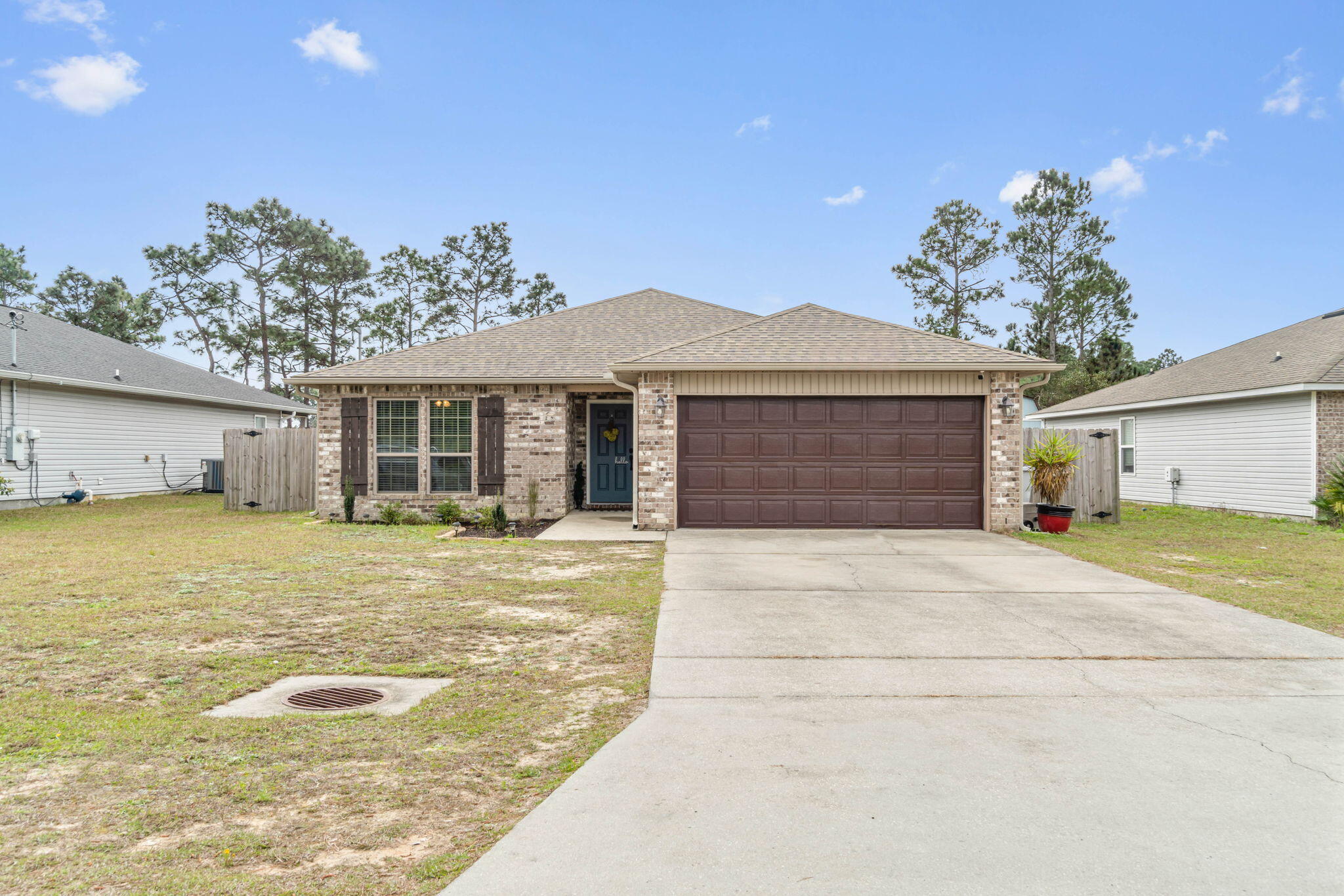 Welcome home to this charming open layout home with a fantastic backyard to entertain in! Built in 2015 and conveniently located minutes to shopping and Navarre's gorgeous white sandy beaches, you'll love this 3 bedroom, 2 bath home with no HOA. Pull into the driveway and enter inside to find a large living space with a vaulted ceiling and newly installed luxury vinyl plank flooring throughout! The kitchen features granite counters with a 17'' raised breakfast bar, walk in pantry, and stainless steel appliances. The separate dining area has sliding glass doors that enter into the covered back patio that's been beautifully extended within the fully fenced in backyard to include a fantastic entertaining area with a 16x26 paver patio, custom paver BBQ (grill will convey!), a 10x12 covered pergola, and a fire pit area for enjoying Florida evenings! The massively deep 200ft lot also has a storage building, and a kid's playground that will convey (batting cage will not). Back inside you'll find the owner's suite through double doors, and a bathroom you'll love with a walk in tiled shower, separate soaking tub, double vanities, private water closet, and a HUGE walk in closet with custom organizer. The other two nice sized bedrooms are found on the other side of the house and each have ample closet space with full bathroom between them. Through the kitchen you'll find the interior laundry room which leads to the 2 car garage. Also, the HVAC is only 2 years old! Don't delay on seeing this home closet to everything Navarre has to offer and a short commute to Hurlburt Field.  --