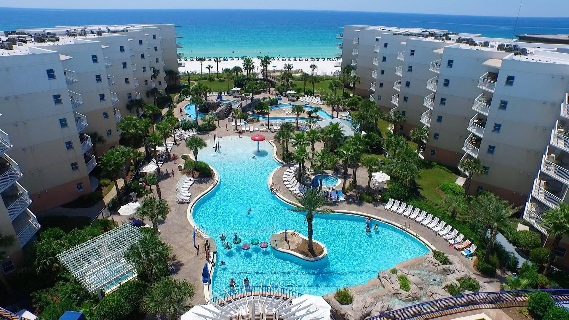 Paradise awaits! Don't miss this opportunity to purchase a fully updated interior facing condo at Okaloosa Island's premier vacation resort! In addition to 2 beds and 2 baths, this beautiful fully furnished unit has bunk beds and a pull out sofa sleeping 8 guests! This fantastic floor plan underwent a gorgeous renovation and with the carpet replaced with wood look tile you don't have to worry about carpet cleans! Enjoy the new paint, new decor and updated lighting, and almost all new furniture and be sure to check out the list of seller updates. Conveniently the unit features an interior washer and dryer and the fully stocked kitchen has granite counters and stainless appliances, and has all the amenities a modern guest is looking for! Have peace of mind with an HVAC replaced in 2017 and  water heater replaced in 2019. Enjoy lounging on the spacious balcony overlooking the tropical oasis, or take a quick elevator ride down to the pool deck and enjoy Waterscape's amazing amenities! Waterscape Condominiums has a two tiered pool deck separated by a 10-foot waterfall. The lower pool deck includes a large zero entry pool with spray toys and lily pads for the young at heart. The resort's lower pool deck features a long lazy river for you to float down on resort inner tubes. The upper deck houses a seasonally heated pool. There is an enclosed children's splash area on the upper pool deck that features water features for young children and a covered play area for maximum sun protection. There are two hot tubs located in the tropical oasis for your relaxation along with gas grills and even a Fudpuckers Tiki hut ready to serve all your food and drink needs - there's no reason to even leave the resort! In addition to handicap lifts around the pools and designated hot tub, the resort updated and expanded their boardwalk to the beach to be handicapped accessible. Don't miss out on this perfect vacation rental opportunity!