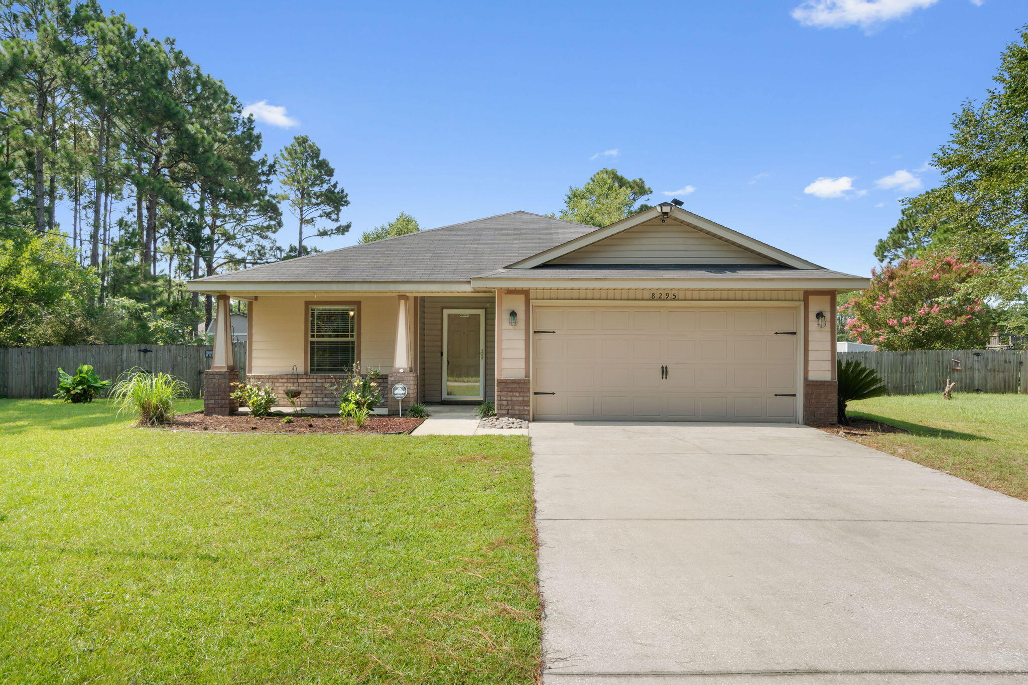 Welcome home to this adorable craftsman style 3 bedroom/2 bathroom Navarre home nestled on almost half an acre with an above ground pool just 3 miles to beautiful Navarre Beach and a short commute to Hurlburt Field! To make it even better, the Sellers will be paying off the solar panels in full at closing, so you will enjoy those energy savings!! Walk up to the front door and find a great covered porch adorned by craftsman style columns. Enter through the storm door and you'll find a fantastic split floor plan with two great sized bedrooms with ample closet space and a shared full bathroom at the front of the house through an archway, and the owner's suite at the back. Hard surface flooring extends throughout other than recently professionally cleaned carpet in the bedrooms. Walk through the other archway and you'll find the kitchen with plenty of cabinet space and stainless steel appliances along with a pantry. The laundry area is inside the house, and the washer and dryer will convey! You will love the huge living room complete with a vaulted ceiling that's open to the dining area to enjoy that open concept feel! The owner's suite is a great sized room facing the back of the house with an en suite featuring double vanities and a large walk in closet. Outside you'll enjoy relaxing on the covered back porch or in the above ground pool! This massive backyard has all the room you're looking for and NO HOA! There's a great sized backyard storage building and even a chicken coop! The Nest thermostat and camera system will convey. Enjoy this convenient location in a home that checks all the boxes! Roof and HVAC are 2012 and water heater was replaced in 2021. There is also a preventative termite bond on the house for protection!