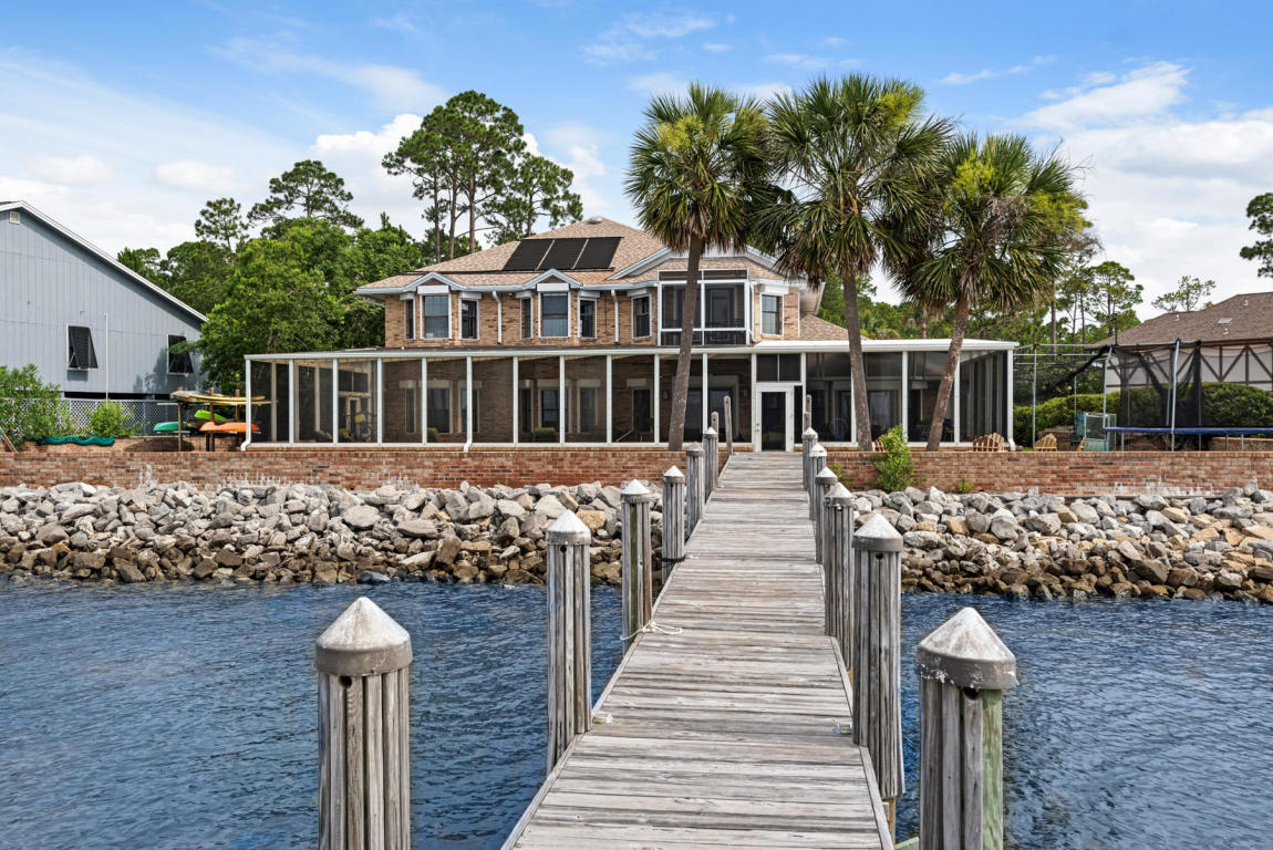 Panoramic water-views as far as Sandestin across to Crab Island. Beautiful sunsets and the tranquil breeze from the Choctawhatchee Bay is what you'll experience living in this waterfront home on the Bay.
Nestled on a quiet cul-de-sac, this home has been newly renovated and certainly won't disappoint. As you walk through the front door you will be impressed by the water views across the home. The foyer opens up to a soaring ceiling and staircase just off to your right which leads you to the second story loft and upstairs living quarters or head straight down the corridor to the lower level bedrooms, one of them has an access door to the laundry room/pantry. Straight ahead from the foyer beyond the stairway is an entertainment room with wet bar and columns to separate from the large