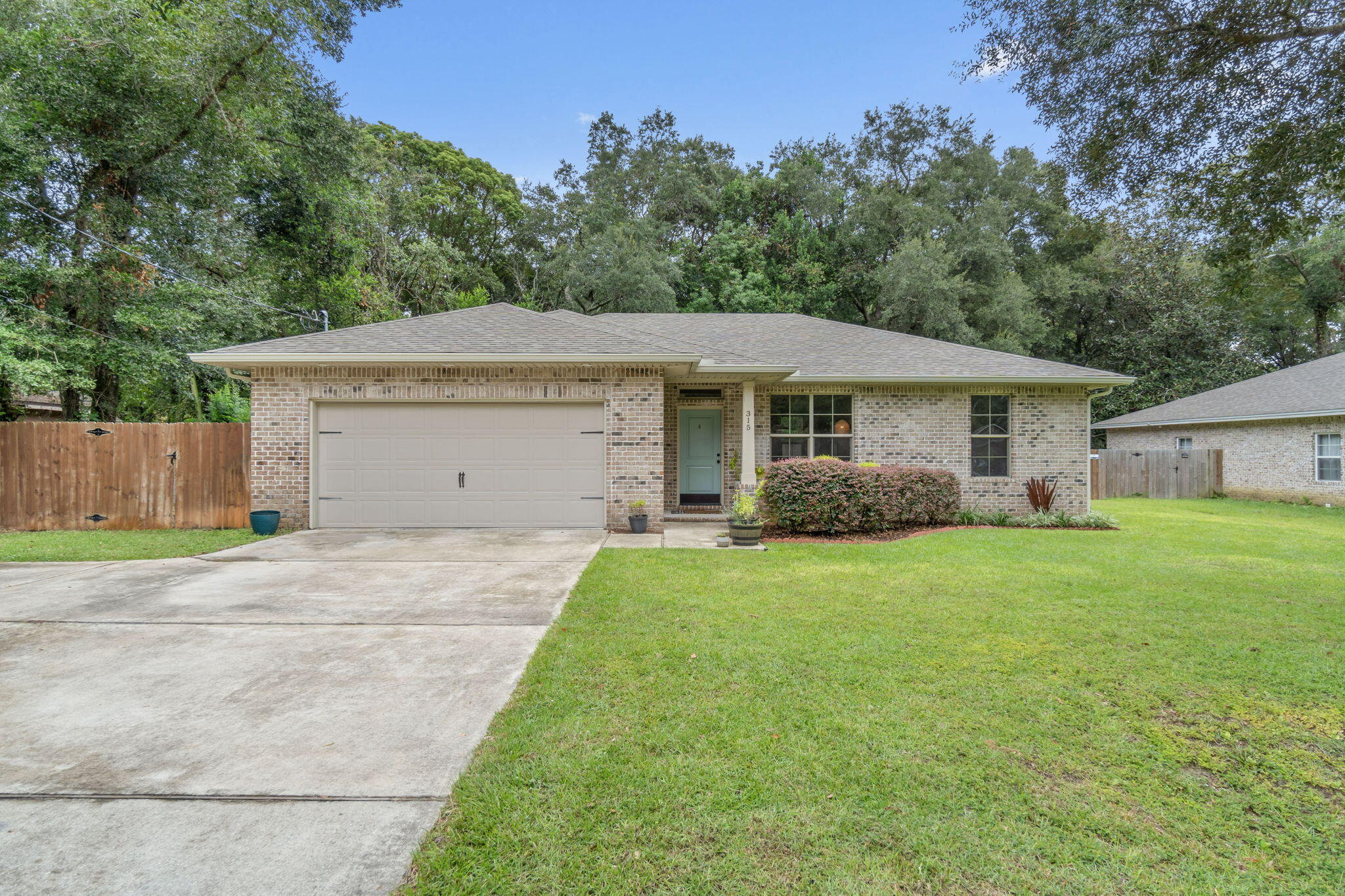 Welcome home to this stunning 2018 built home conveniently located in the heart of Niceville! Perfectly positioned near shopping, restaurants, and more - this all brick 3 bedroom, 2 bath home has all the updated finishes you want in your new home. The open and split floor plan features a fantastic open living space and outside you'll find a covered back patio inside the fenced in yard. The living room is open to the well appointed kitchen which has granite countertops, stainless steel appliances, drop down pendant and recessed lighting, and there is a great sized dining space. The owner's suite is located on one side of the house and the nice sized bedroom leads to the en suite where you'll enjoy double vanities, a walk in closet, and a shower/tub combo. The other two bedrooms are located on the other side of the house with a well appointed bathroom between them. Enjoy quality laminate flooring in the great room area with carpet only in the bedrooms and tile in the bathrooms and interior laundry room. Complete with a 2 car garage and extended driveway pad you're sure to love this all brick beauty!