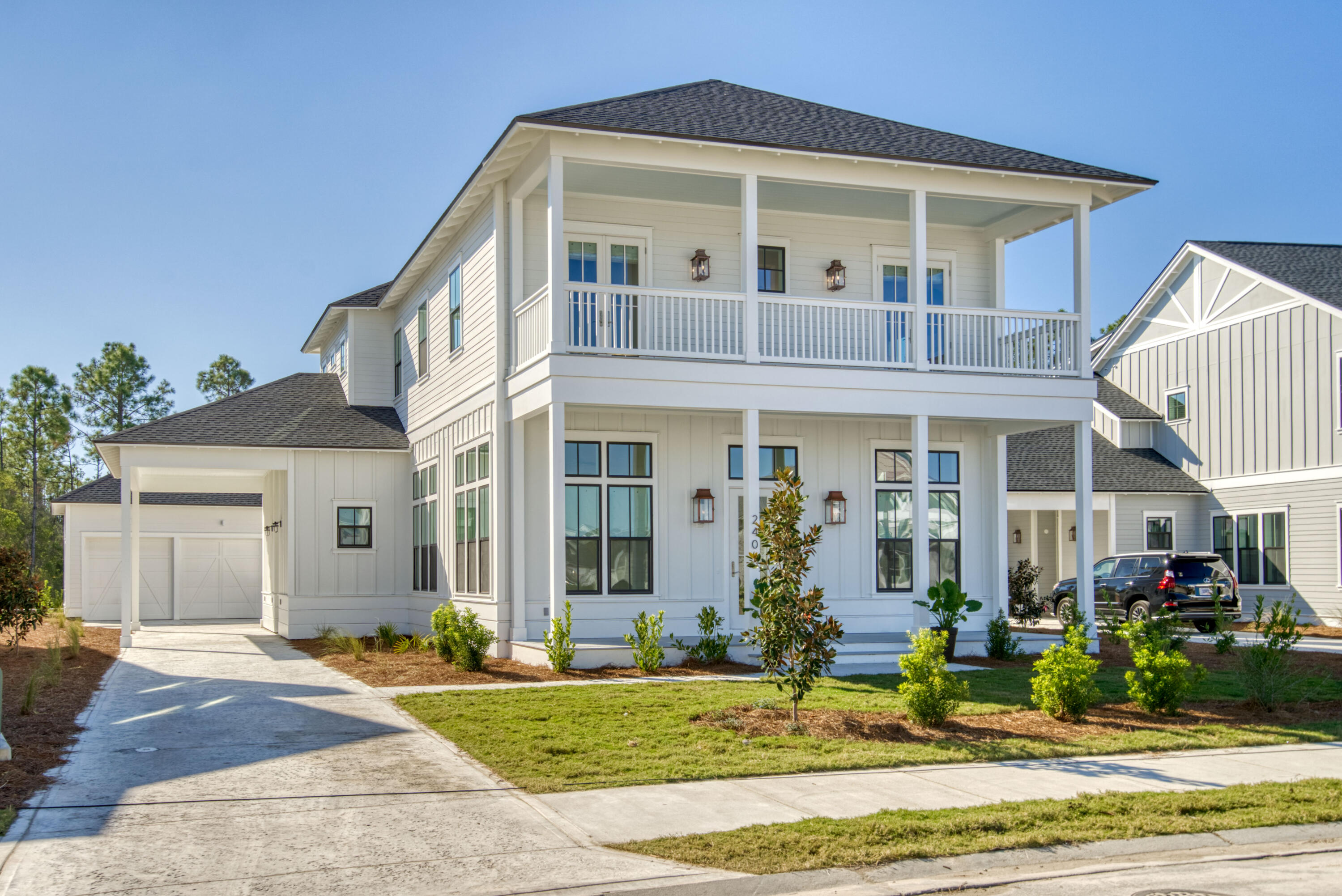 New construction, NEVER LIVED IN, highly curated interiors by Mary Hawthorne, this Arkon Group, 3,256 sf Ellis floor plan, evokes feelings of relaxed elegance with warm coastal charm.  Offered, AS VIEWED, the meticulously decorated and high end furnishings compliment the luxury finishes like wire-brushed hardwood flooring, quartz countertops, unique tile in each bathroom, shiplap accents, stainless Thermador stove, Sub-Zero refrigerator, with added upgrades like wine cooler and custom cabinetry in kitchen.  The modern layout with 4 BR 41/2 baths includes first and second floor primary suites, study, gas FP in living room plus upstairs media/loft area and office space off the primary BR.  Perfectly situated on an oversized lot with a landscaped buffer that backs up to a nature preserve adding privacy and allowing peaceful views.  1,126 sf of covered porches with screened-in lanai with custom wood ceilings, summer kitchen, outdoor shower, Private pool with UPGRADED pool spa and heater.  Gas, electric, and water stubbed out behind the 2-car detached garage + carport, if new Owner wants to add a gazebo, fireplace, fans, etc.  MOVE IN for the Holidays!