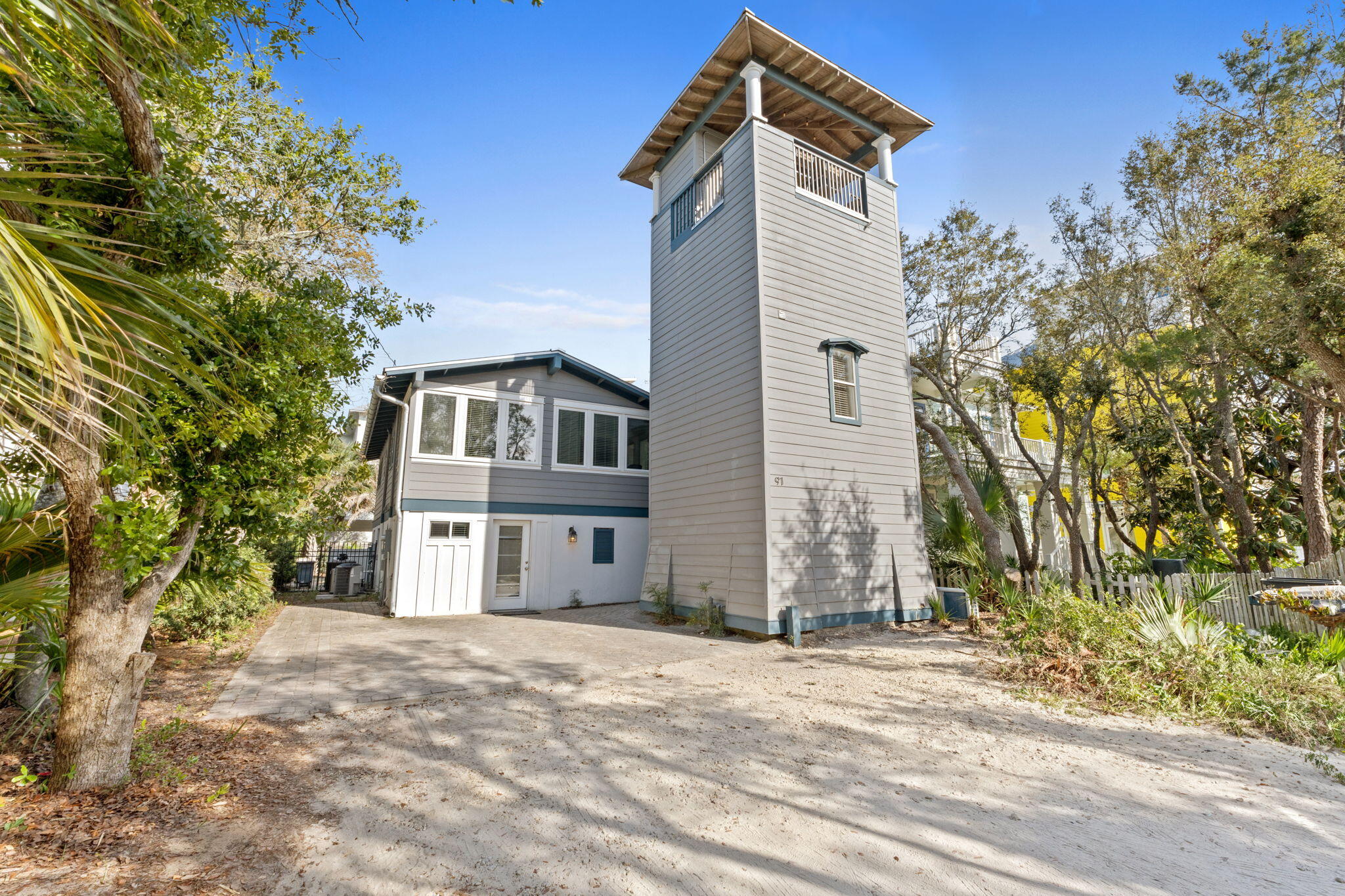 Welcome to 91 Cypress Hill Road, a hidden gem located on one of Old Seagrove's most coveted streets. Tucked away among mature Chapman oaks in an exclusive enclave, this European-inspired retreat perfectly balances privacy, charm, and proximity to both the Gulf of Mexico and the vibrant heart of Seaside. Designed with versatility and comfort in mind, this unique property features three interconnected living quarters, offering ideal accommodations for extended families or multiple groups. The thoughtfully designed layout provides ample communal spaces for gathering, along with private retreats for rest and relaxation.

The main home offers three bedrooms, two additional sleeping areas, two full bathrooms, and one half bath. Outdoor living is seamlessly integrated with a private 12' x 34' pool, complete with water features, a tanning shelf, and lush tropical landscaping. Multiple covered porches, a gas grill, and a private outdoor shower create an inviting environment for alfresco dining and lounging.

A separate four-story tower serves as the perfect guest retreat or teen hideaway, featuring a second kitchenette, additional lounge space, and a Gulf-view observation deck ideal for sunset viewing.

Highlights of this extraordinary property include sleeping accommodations for up to 14 guests, multiple kitchens and living areas offering ultimate flexibility, a private apartment complete with a full bath, kitchenette, and laundry, and expansive outdoor spaces including covered porches and an observation deck. Additional features such as a gas grill, a private outdoor shower, and driveway parking for four vehicles further enhance the comfort and convenience of this remarkable home.

Ideally situated within a short stroll to the sugar-white sands of Seagrove Beach and the boutiques, dining, and entertainment of Seaside, 91 Cypress Hill Road offers a rare opportunity to own a truly versatile beach retreat  equally suited for personal enjoyment or lucrative rental income.