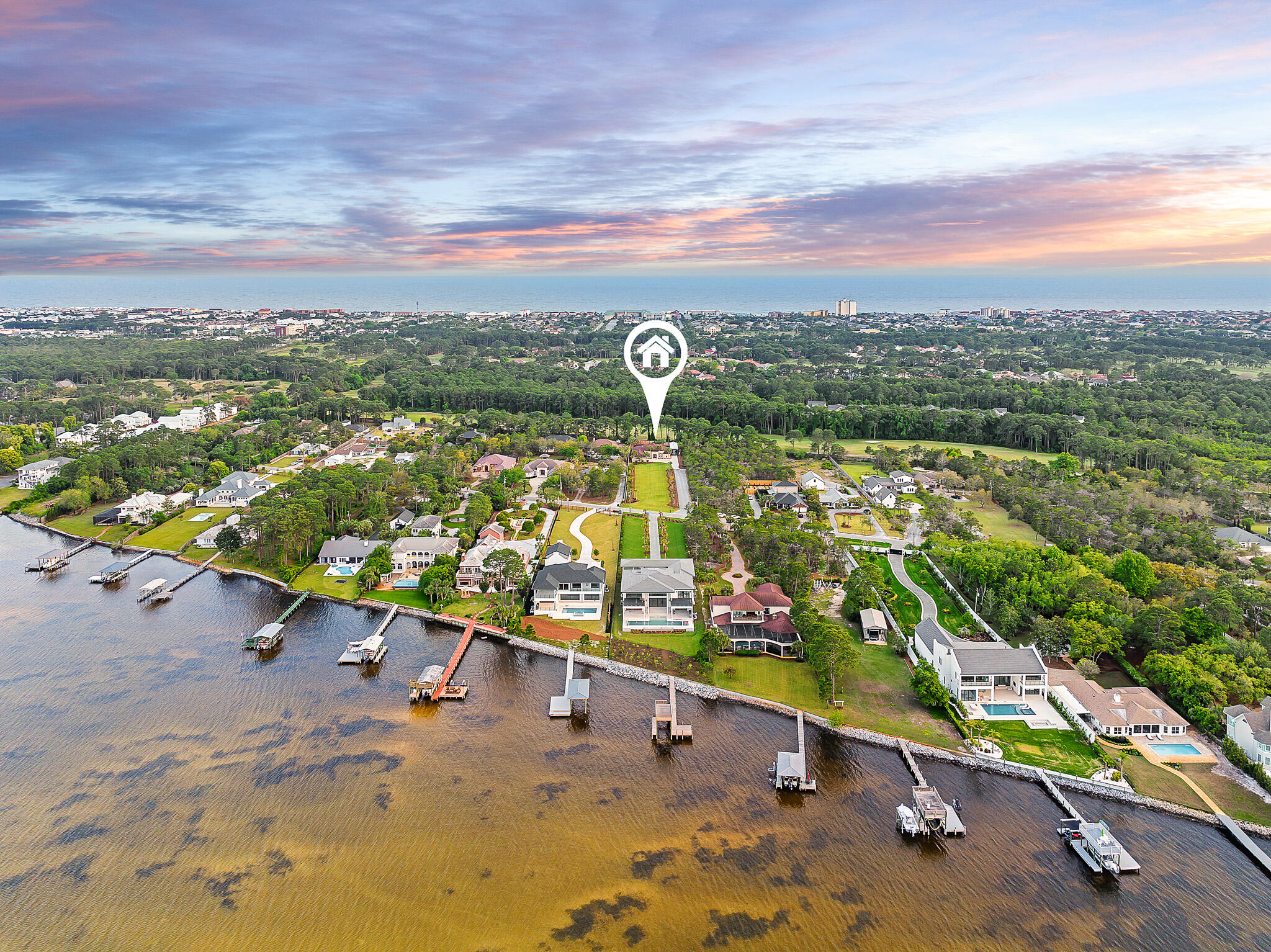 Introducing an elegant single-family home that epitomizes a community of waterfront charm and luxurious living in Miramar Beach's Whispering Oaks; which stands in a tranquil neighborhood, offering a lifestyle of comfort and convenience just minutes away from the beach, eclectic dining, and shopping. Positioned on a 1.04 acre lot ensuring privacy and an estate experience. The resort-like, screened-in, heated saltwater pool is perfect for year round leisurely swims and lively pool parties. The outdoor area is complemented by an outdoor kitchen complete with top-of-the-line appliances, including an Dacor built-in grill and hood, warming drawer, vevor pool refrigerator, and an entertainment center. The outdoor covered dining and a romantic fireplace nook is perfect for cool evenings relaxing to the sounds of your pool garden and waterfall.
 With a flair for the extraordinary, this custom-built, "New Orleans" style home redefines luxury. Inside the 3,233 sq ft home, the living room, equipped with surround sound, offers a warm space perfect for those cherished friends and family movie nights or for relaxation after a long day. The chef's kitchen is a dynamic focal point of the home. There is Subzero refrigerator, two center island cooling drawers, dacor warming drawer, and custom oak cabinetry highlighted by a tuscan influenced hood. The focal point of the house is perfect for gatherings with breakfast bar seating and a dining area leading to your outdoor oasis.
There are five bedrooms and one serves as a fitness room. In addition a private office fronting the tropical yard with Choctawatchee Bay views. The primary suite flanks the outdoor oasis with pool and tropical views of the extensive backyard with privacy fencing. Featuring double tray ceilings with uplighting and an enormous ensuite bath with a glass enclosed waterfall shower, soaking tub, and dual walk in closets.
Bring your fleet of cars and your large traveling motorhome complete with a covered garage space and hook-up. An unparalleled opportunity to purchase in an emerging elite neighborhood of Whispering Oaks.