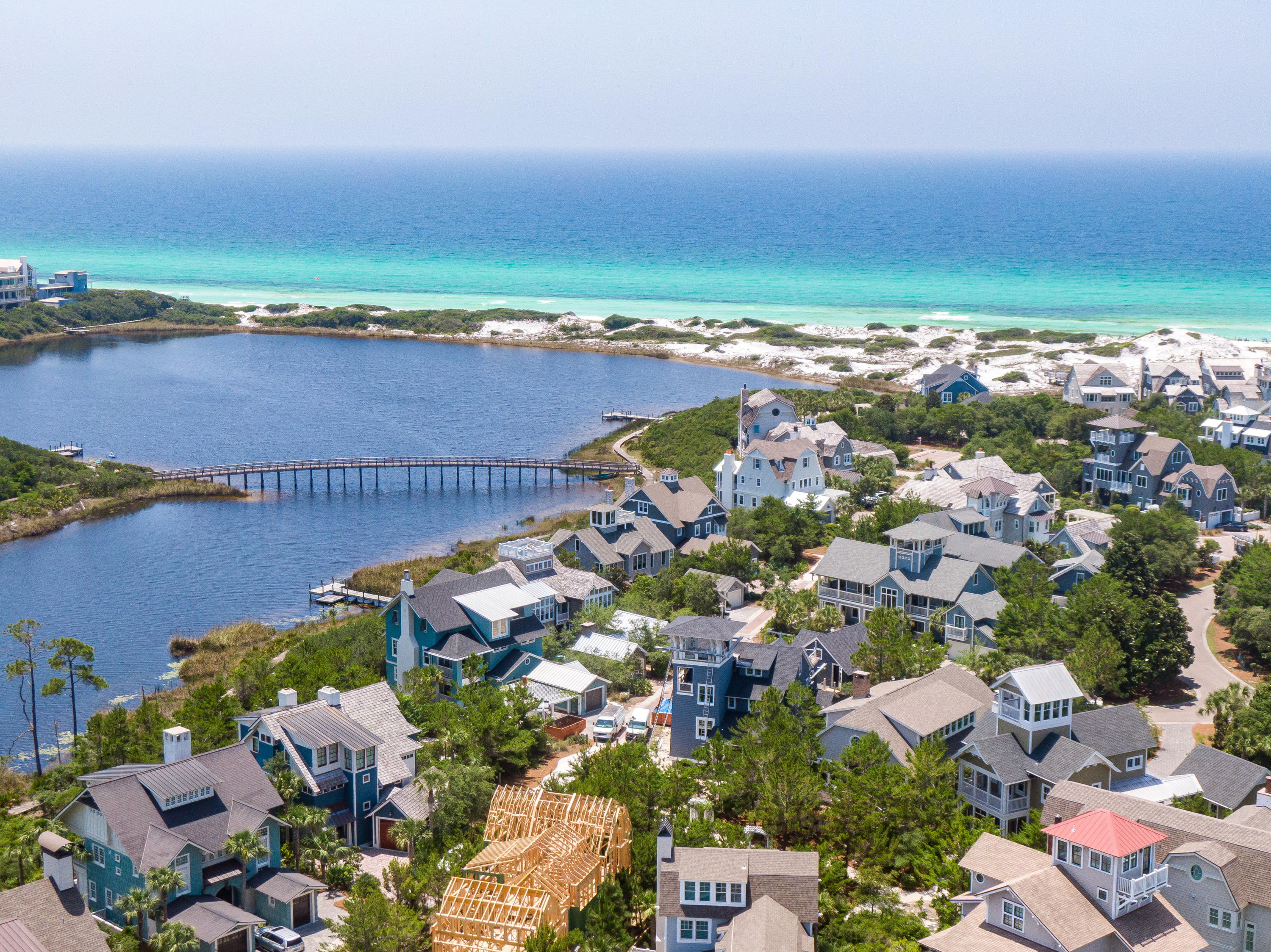 Offering luxurious living for the savvy, discerning home buyer in the Bridges section of WaterSound Beach; this 4-bedroom, 4.5 bath 3,200 square foot home is the perfect balance of simplicity and first class living, privacy and connectivity to the emerald waters beyond the coastal dune walkovers.
The residence compliments its surroundings perfectly with such a pleasingly simple design that exudes the same peace and tranquility one enjoys from sitting at the shore and listening to the Gulf of Mexico. A gas fireplace, flanked by beautifully crafted built-ins, graces lofty and open great room where ample seating flows into the dining area with breakfast bar, offering an ideal location for your next family gathering.
The spacious gourmet kitchen offers a suite of stainless-steel appliances, custom cabinetry, beautiful countertops with a perfectly anchored island. The master retreat offers privacy and a beautiful en suite with custom tile. Two additional guest rooms with private bath and a carriage house complete the suite of bedrooms. A two-car garage provides amble space for guests and beach toys alike.