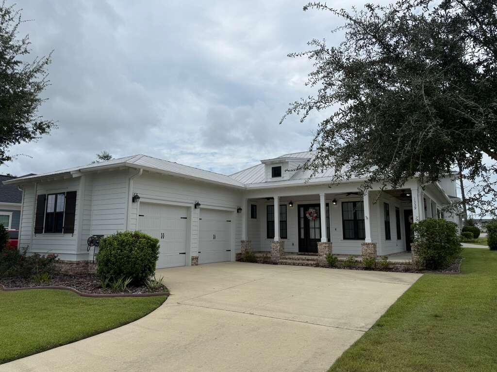 Full of charm and character, this Craftsman-style home is located in Niceville's premier community, Deer Moss Creek. This one-story residence features three bedrooms, two full baths, and a desirable open-concept floor plan designed for modern living. A welcoming wraparound front porch greets you and your guests before entering the bright and airy living room and kitchen, highlighted by 10-foot ceilings, tall dormer windows, and beautiful wood-look tile flooring throughout.

The kitchen is a true showpiece, offering white quartz countertops, white shaker-style soft-close cabinetry, stainless steel appliances, a gas range, a farmhouse sink, open built-in shelving, and a spacious walk-in pantry, perfect for keeping everything organized. Just off the kitchen, a convenient laundry room provides additional storage and functionality.

The private primary suite features a generous walk-in closet and a spa-inspired bathroom with double vanities, a tiled glass shower, and a relaxing soaking tub. Two additional bedrooms are thoughtfully designed to provide comfort and versatility, ideal for guests, a home office, or a family. The guest bathroom features a stylish walk-in glass shower, modern fixtures, and elegant finishes, creating a welcoming space for visitors.

An oversized two-car garage offers plenty of room for parking and storage. Outside, the wraparound porch and beautifully landscaped surroundings encourage outdoor living and connection with nature.

Perfectly located just minutes from Eglin AFB, Destin-Fort Walton Beach Airport (VPS), Northwest Florida State College, Twin Cities Hospital, and the white-sand beaches of Destin, this home combines comfort, convenience, and lifestyle. Deer Moss Creek® is thoughtfully planned around its natural surroundings, featuring parks, bike paths, wide sidewalks, and beautifully designed streets that invite residents to enjoy the outdoors.

Pets may be considered on a case-by-case basis with owner approval and a non-refundable pet fee. Smoking and vaping are not permitted inside the home.