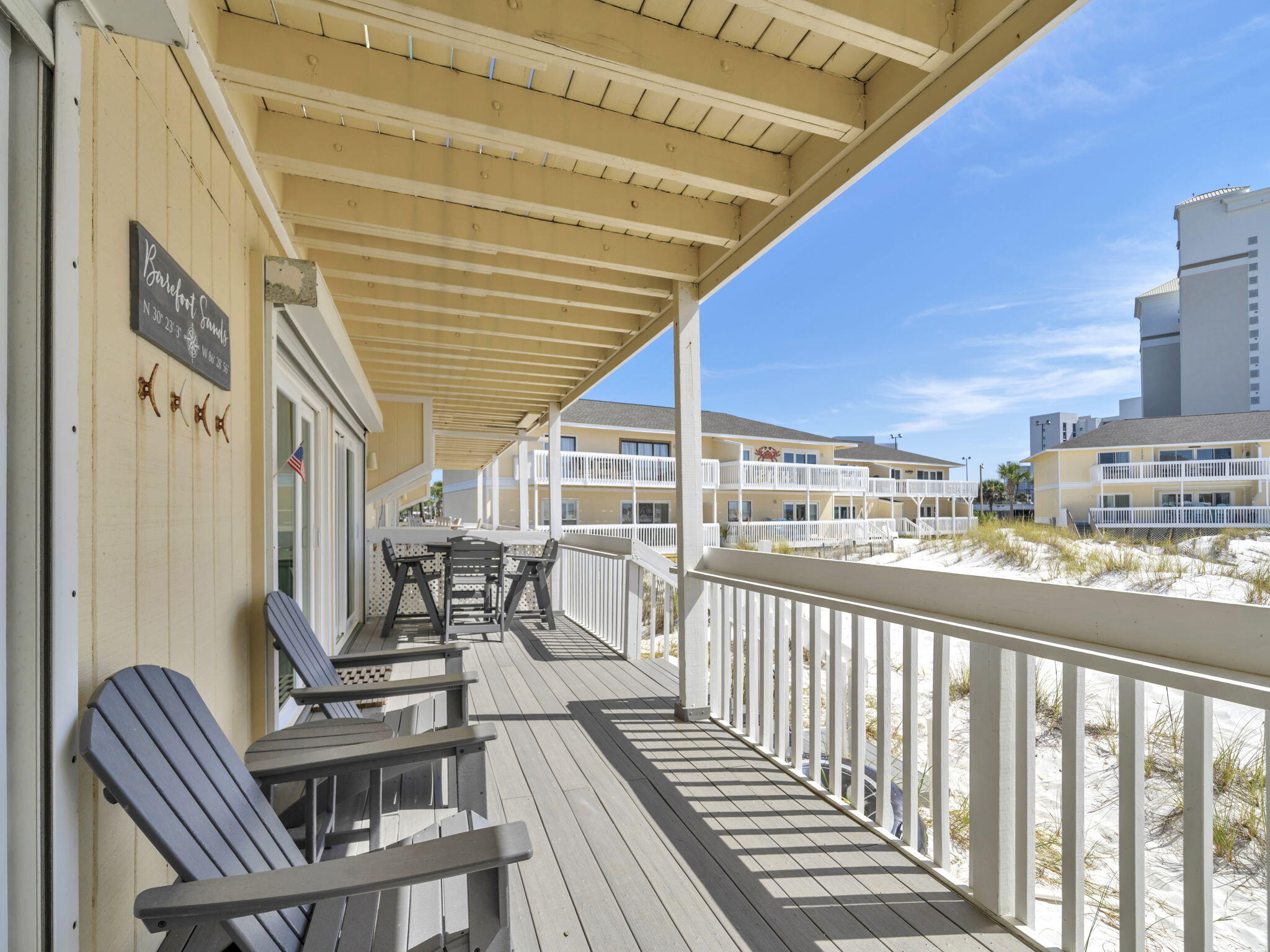 As soon as you leave the deck of this lovely beach condo you will be in the sand. Fully renovated and updated , chic and stylish.  Stainless appliances, quartz counter tops, and attention to detail everywhere. Custom cabinets in the kitchen, hurricane shutters, and heavy duty storm rated sliding glass doors. Trex composite decking and Polywood brand high top outdoor furniture.  Custom Birch ceiling in the hallway and kitchen. The HVAC was replace in June 2024 and has a digital thermometer with remote access.  Ship lap, molding, planation shutters, USB outlets, and smooth ceiling make this condo stand out. Plenty of room for the whole family and you can also take advantage of  vacation rentals. Many great amenities include tennis, chip and putt golf course, marina, and on site restaurant. Many fun attractions in the area. A complete list of all the upgrades and benefits are in the documents section.