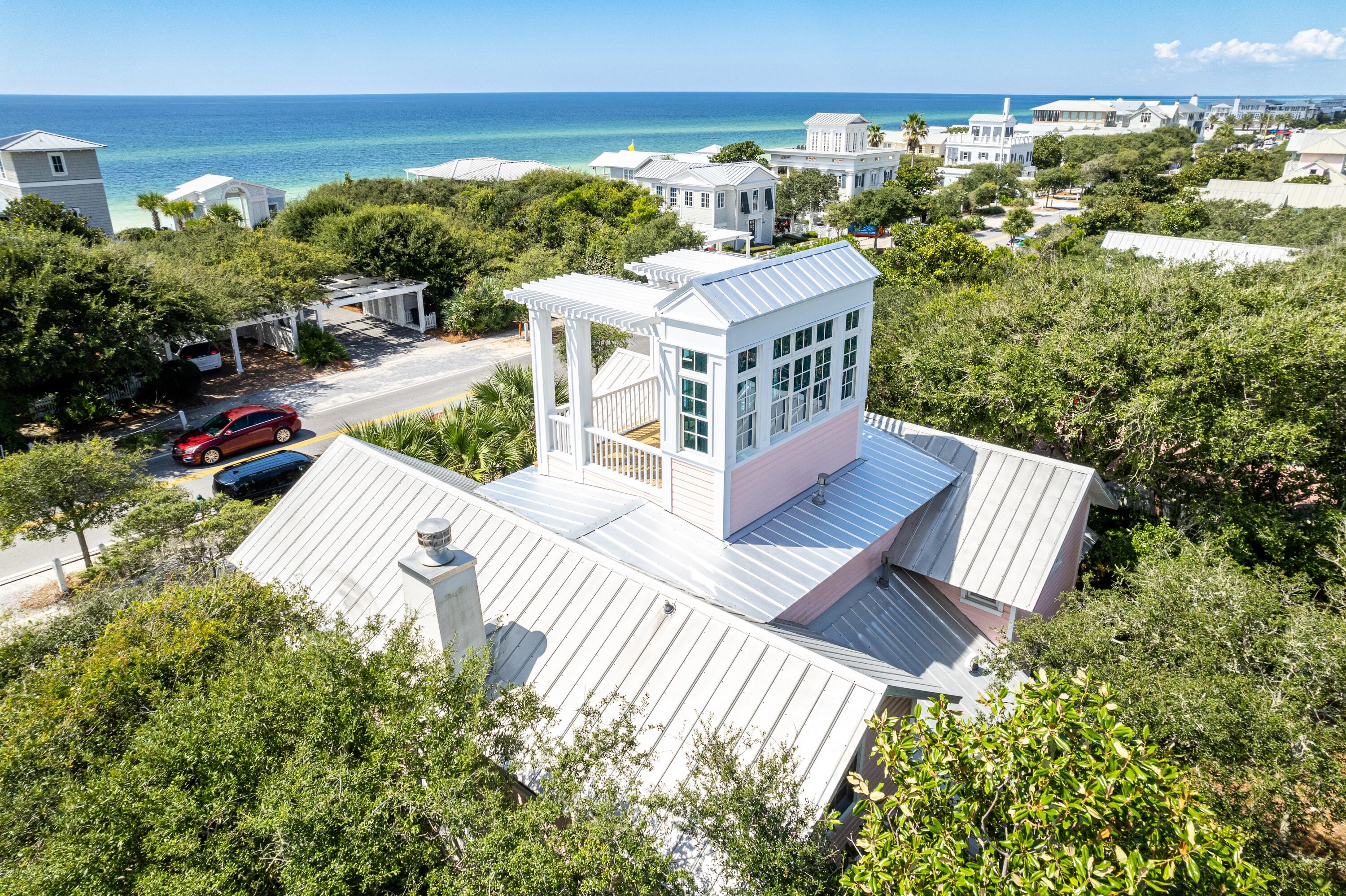 One doesn't have to travel to New York City to experience the 'Upper East Side.' This lovely
version is nestled directly across from the iconic Tupelo Street beach-access pavilion, and the Gulf
views are stunning! Location, location, location may sound cliché, but it's undeniably true with the
location of Upper East Side. This prime spot on 30A is mere steps from the beach, and will
fast become your favorite beach getaway.

Upon entering, you are greeted by a lovely sunlit room featuring a beautiful kitchen, dining area, bonus room with a trundle bed, full bathroom, and a convenient laundry room. Proceeding down the hallway, you will discover a gorgeous living room with a fireplace, wet bar, and sunroom. Two separate doors lead to either the front or back porches, allowing  for easy access to outdoor spaces.
The stairs off the kitchen area take you to the second floor where you will find a spacious master
suite with en-suite bathroom, and a delightful sunroom/sitting room. A guest bedroom with its
en-suite bathroom is separated from the master by a sundeck. Venture further up to the tower for panoramic, never-ending views of the Gulf and unforgettable sunsets! This is the true meaning of "location."

Additionally, a storage shed behind the home contains Kevlar storm shutters for added peace of mind.