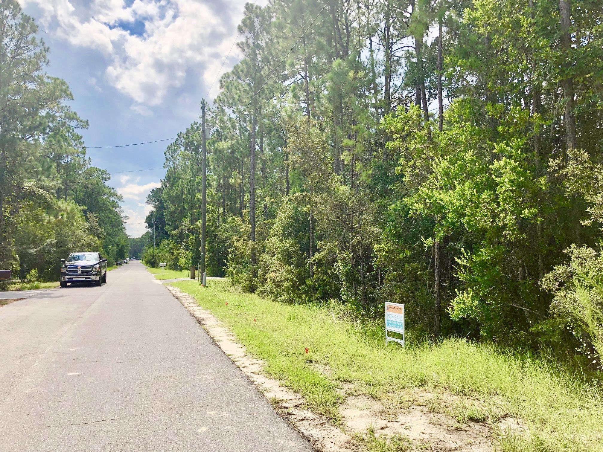 Great high and dry buildable lot in X flood zone, just steps from Choctawhatchee Bay, with a boat launch and beach right there. This lot has no wetlands, a recent delineation has been done and it's been recently surveyed with corner markers at every corner. This lot has public water and sewer and power available at lot line. Beautiful selection of trees on the property, including Magnolias, Live Oaks, Palmettos and Pines. Surrounded by new construction, minutes to 30A, this quiet, private lot is a great investment! No HOA's or build out time. Local financing available, call for details. Agent is seller/owner.