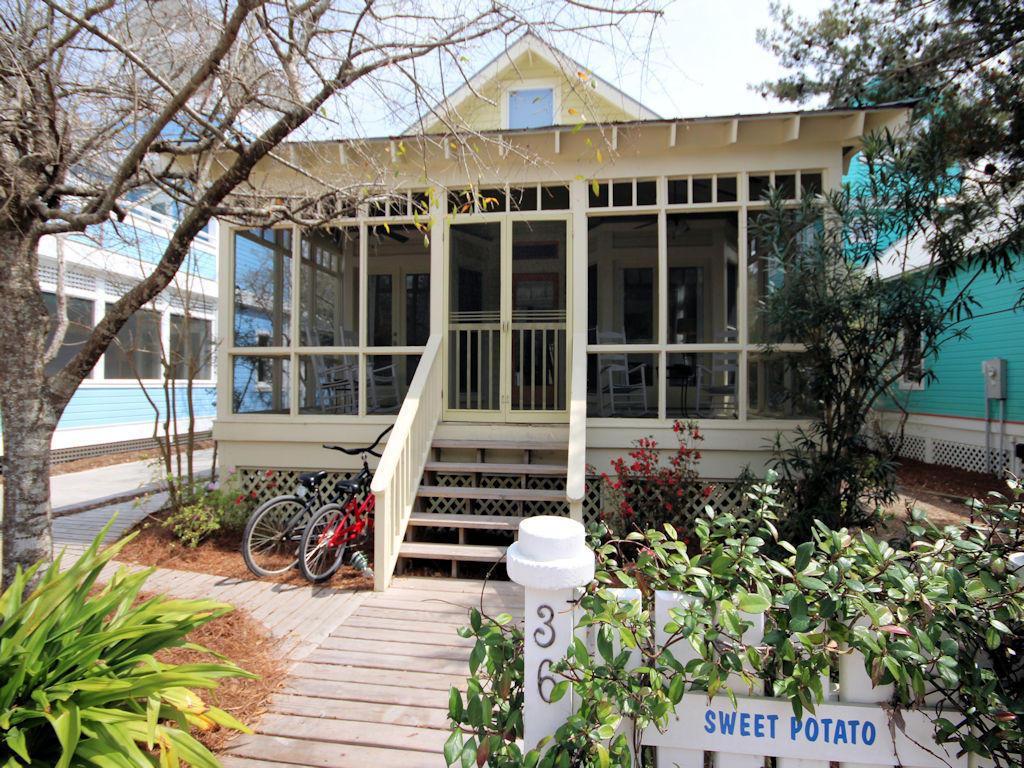 Bedroom & bath count include main cottage & guest cottage. Main cottage 2 bedrooms w/sleeping loft, 2 baths. Guest cottage 1 bed, 1 bath. Square footage is total of Main house and Guest cottage. This traditional Florida beach bungalow will bring back favorite memories of your family's summer vacations. Picnic on the front screened porch or relax a while in the rocking chairs after a fun day on the beach. The main cottage has a comfortable floor plan all on one level. Vaulted ceiling in the living, dining and kitchen area. Children can scamper up a ladder to the sleeping loft above the living area and feel as if they are on a camping adventure. Two bedrooms, each with full baths with access to private outdoor shower, flank one side of the cottage. Updated kitchen features granite counter tops, farmhouse kitchen sink with breakfast bar open to dining and living area. Spacious laundry room with ample storage off kitchen. The two story guest cottage is tucked away in the rear yard and fronts one of Seaside's many hidden footpaths. Bedroom with full bath and laundry on first level. Living, dining, kitchen and balcony on second level. Onsite private parking and outdoor storage. Main cottage 2 bedrooms with sleeping loft, guest cottage 1 bedroom 1 bath.