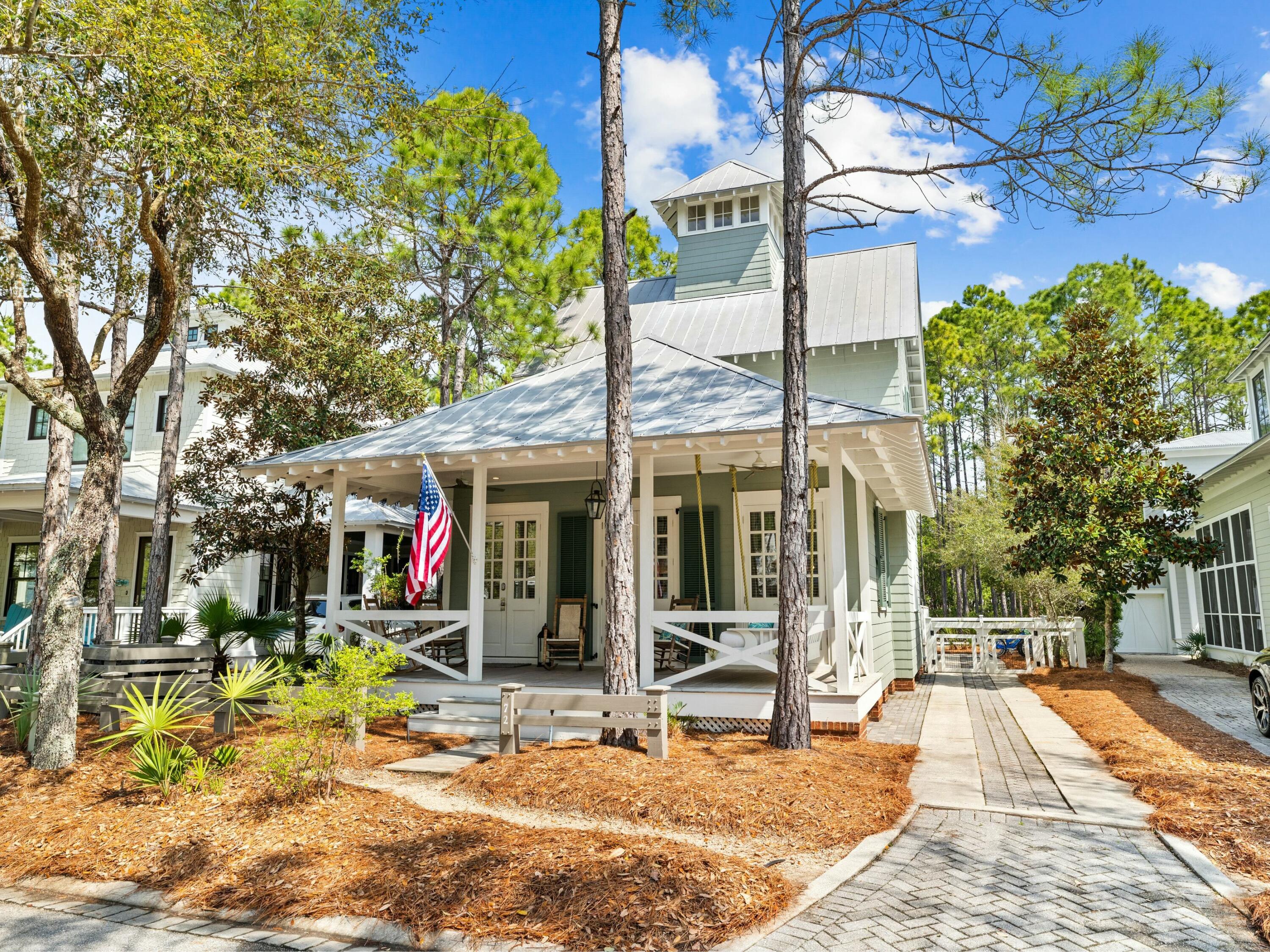 Tucked into one of WaterColor's most desirable Phase II locations, this beautifully maintained home on Thicket Circle offers peace, privacy and quick access to the very best of 30A living. Bordered by a small park in front and green space behind, the setting feels both spacious and serene — ideal for those seeking a true coastal retreat with every amenity close at hand. A deep front porch, framed by mature landscaping, sets the tone for relaxed mornings and slow evenings. Step inside to a bright, open layout where the front-facing living room flows effortlessly into the dining area and updated kitchen. French doors lead from the dining room to a side deck, perfect for evening grilling or afternoon lounging. Thoughtful built-ins line the hallway, offering practical storage that blends seamlessly with the home's clean design. The primary suite is privately located on the first floor, tucked at the rear of the home for maximum privacy. A walk-in shower and generous layout make it a comfortable everyday escape. Upstairs, two guest bedrooms each feature their own ensuite bathrooms, offering comfort and privacy for visitors or family. A powder room and laundry area on the first floor add to the home's convenience. Outside, the long driveway provides ample parking and a large, fenced-in backyard big enough to add on, if desired.  Whether you're heading to the Camp District playground and pool just around the corner or cruising to the gulf-front beach club, every destination is minutes away. WaterColor amenities include access to multiple pools, tennis and pickleball courts, a lakeside boat house, walking trails, and of course, the gulf-front beach club with dining and panoramic views. Publix, shops, and restaurants in WaterColor and Seaside, Florida, are a short ride away. With its peaceful location, functional layout and strong rental potential, this home is being sold fully furnished turnkey and a rare opportunity to enjoy WaterColor at its finest.