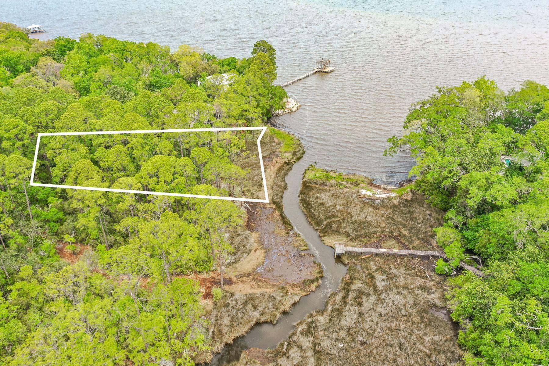 WE ARE TAKING BACKUP OFFERS. This lot will have some views of the bay and it situated in a quiet neighborhood with a few restrictions on building. It backs up to a small canal that leads into the bay, where you can put in your canoe or kayak