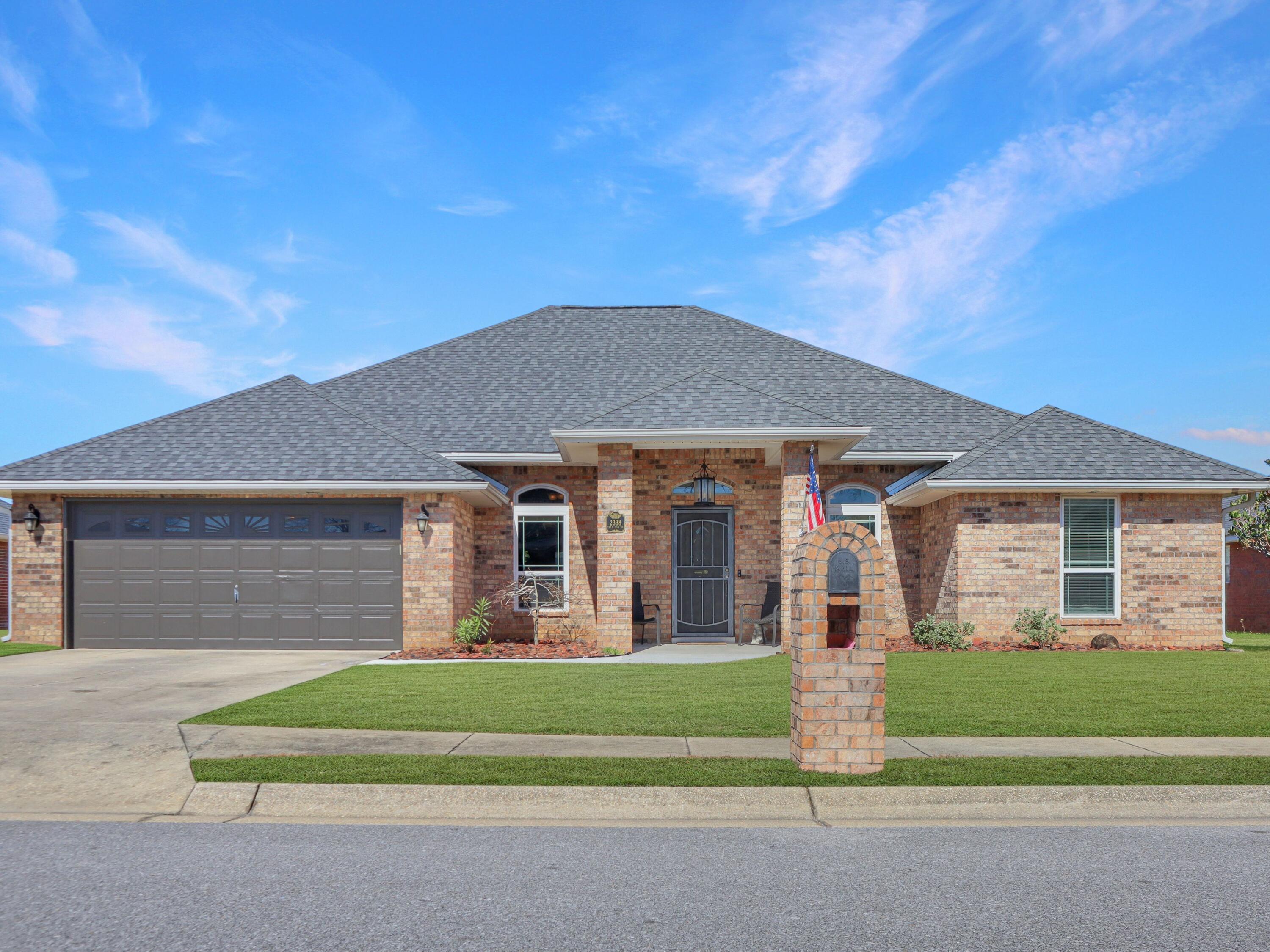 From the moment you arrive, this all-brick home makes a strong first impression with extra-wide sidewalks and a welcoming entry that leads into soaring cathedral ceilings and warm, timeless finishes. Travertine floors extend through the main living areas, setting the tone for an open yet well-defined layout designed for both everyday living and entertaining. Just off the entry, a private office with doors offers flexibility for work from home, a guest space, or a fourth bedroom if needed. Across the hall, the formal dining room is framed by encased doorways, crown molding, and transom windows that bring in beautiful natural light. The kitchen sits at the heart of the home with wood cabinetry, stainless steel appliances, a five-burner gas range, tile backsplash, and detailed tile inlay. Bar seating connects seamlessly to the living room, where cathedral ceilings, a gas fireplace with a detailed mantel, and built-in shelving create a comfortable gathering space. A breakfast nook adds another casual dining option overlooking the living area. The primary suite is thoughtfully positioned for privacy and features a tray ceiling with crown molding and double doors leading to the glass-enclosed Florida room. The updated bath includes a frameless walk-in tile shower, soaking tub, dual vanities with center storage, accent mirrors, and dual closets. On the opposite side of the home, two additional bedrooms share a guest bath with cultured marble countertops and a tub and shower combination. One guest bedroom offers a deeper closet, while the third bedroom is oversized with a large double closet and direct access to the Florida room, making it ideal for a second living space, studio, gym, or multi-generational use. The glassed-in Florida room overlooks the backyard and pool and offers a peaceful space for relaxing, working, or creating. Outdoors, the fully fenced yard features a kidney-shaped gunite pool with palm trees, a covered outdoor kitchen area, and established landscaping. Gutters surround the home for added function. Additional highlights include a spacious laundry room with extra cabinetry, an epoxy-coated garage floor with cabinetry and workbench, a tankless gas water heater, roof 2021 and a 2024 HVAC system. This home offers space, flexibility, and a layout that adapts beautifully to many lifestyles.