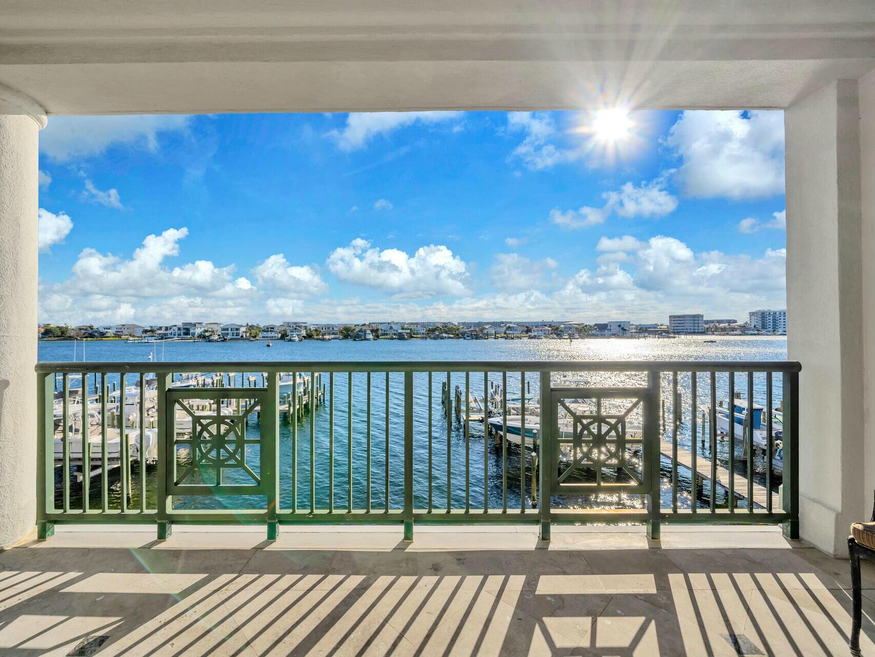 Boating enthusiasts, take note - this RARE Destin property features a large private boat lift complete with a custom fish-cleaning station! This elegantly designed 3BR/ 3BA condo located at Tranquil Harbor is perched on a bluff overlooking the Destin Harbor combines luxury, serenity, and functionalityThis condo comes with a deeded slip featuring a recently installed 20,000lb boat lift, a custom-built large cleaning table, and the ability to accommodate a 36' to 40' boat—one of the few properties on the Destin Harbor with such a capability. Equipped with a full electrical pedestal, water hookup, and a remote control to operate the lift from inside your boat. From the moment you step inside, you're greeted by breathtaking harbor views that flow seamlessly into an open floor plan, giving the space in natural light through corner windows facing east and south.