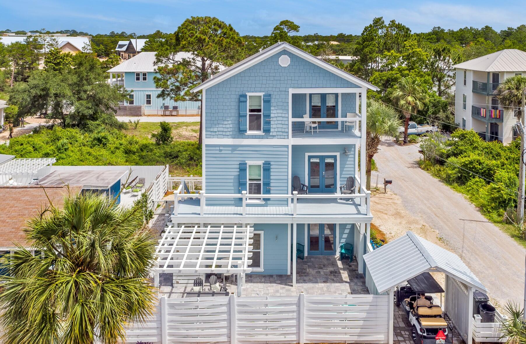 Beach Vacation Home Perfection South of 30A! Projections of $170,000! No HOA. Room for a POOL! A short walk to Eastern Lake Beach Access or the Ramsgate this home is ideal for vacationers and second homeowners, with just the right space to be together or apart. 

This home features a large and very private 1,500 sf fenced patio that is perfect for enjoying outdoor meals, corralling the kids, or washing off in the outdoor shower after a long day at the beach. From the first floor, you'll find the downstairs guestroom, a bunk room with 4 built-in beds each outfitted with lighting, a full bathroom with shower/tub combo, second living space complete with a wet bar with beverage fridge and a laundry area. Located on the second floor is the kitchen and dining area with a large balcony, living area with new sleeper sofa, and half bath. Privately located on the third floor is a huge master suite with French double doors leading to the balcony, a very large walk-in closet, and a large en suite. Another guest room with a beautiful wall treatment and full bath is located just down the hall.

Updated in 2021, the kitchen features a Carrera Blanco quartz countertop, white pearl backsplash, stainless steel appliances, and a breakfast bar with seating for 5 people. Other updates include all new vinyl windows, Benjamin Moore exterior paint, privacy fence, pergola, golf cart carport, and more!

This is a MUST-see!