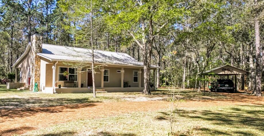 Amazing Property & One owner home! Located in the quiet community of Freeport, FL!  Approx 1.45 Acres includes 3 adjacent lots and a well maintained home.
Expansive front and back porches, open living and a large master with onsuite are just a few reasons to love this place!  The property features a large workshop and two additional outside storage rooms. 
Live, work, play, relax, retire, entertain...you can do it all here!
This one is a MUST SEE!