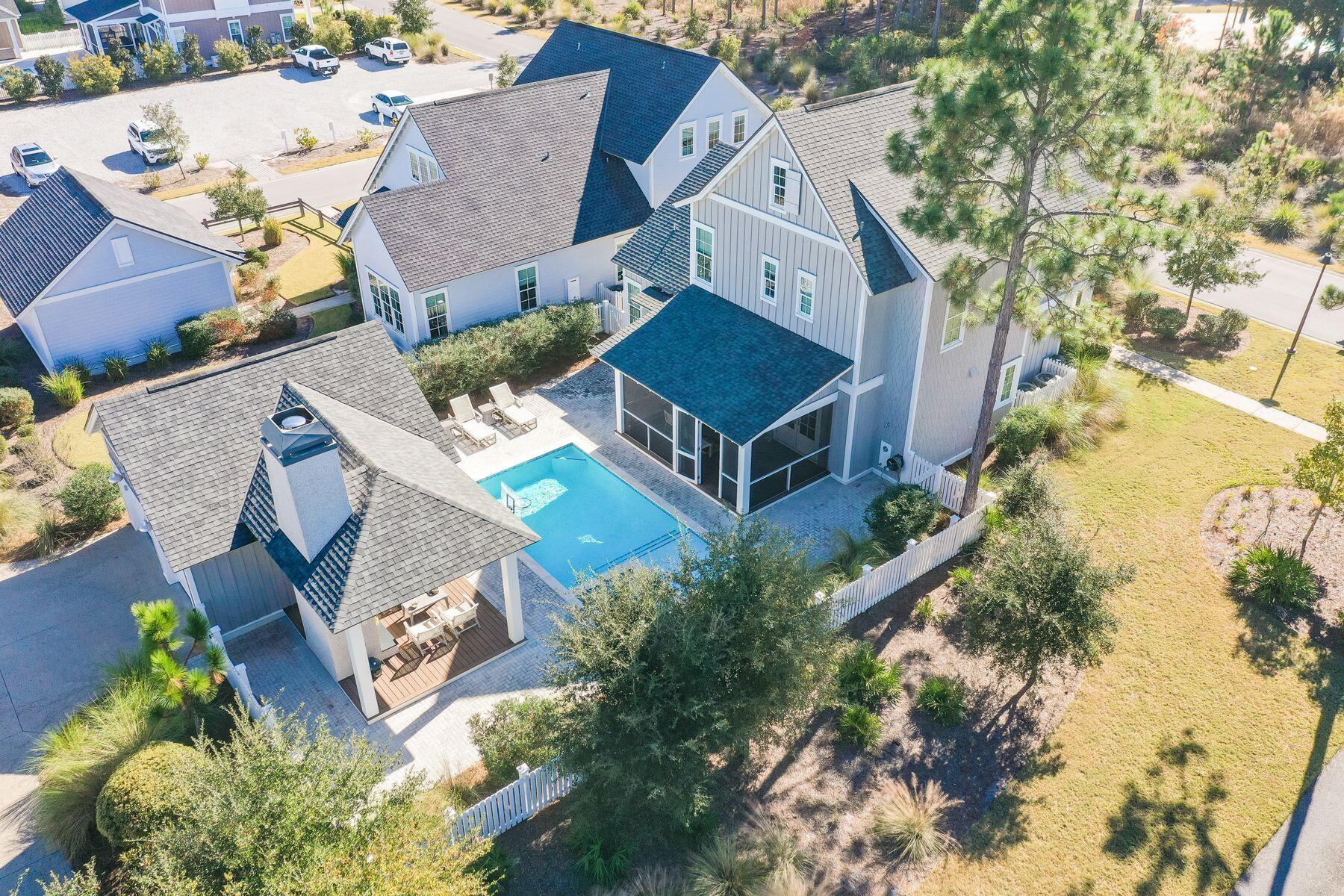 Real estate is all about location and this four-bed, three-and-a-half bath home in WaterSound Origins has that in spades. Located on a lot adjacent to a walking path and right across the street from Origins' community amenities, this home offers convenient entry and exit to the rental-restricted neighborhood and plenty of guest parking. Built in 2018, this 2,512-sq.-ft. upscale retreat has been thoughtfully curated both inside and out with designer lighting, wall coverings and wood flooring as well as a large screened porch, private pool with sun shelf and cabana with a gas fireplace and television for relaxing out of the sun. Inside this Romair-built home, finished with modern and neutral furnishings and decor, you'll find grasscloth wall coverings, 10-ft. ceilings, wire-brushed wood floors, quartz countertops, soft-close cabinets and drawers and a completely upgraded audiovisual system. A large open living area flows seamlessly with the open kitchen and dining area, ideal for entertaining or relaxing. The first-floor owner's suite features a spacious en suite bath with garden tub, shower, walk-in closet and access to the backyard oasis. On the second floor, an additional living area is ideal for guests or children, conveniently located near three guest rooms and two full baths. Outside, sit by the gas fireplace under the cabana, accessible from the home's French doors to the screened porch and pool area, which is fenced for safety and privacy. A rear-entry two-car garage with a spacious driveway allows plenty of room for a variety of vehicles. WaterSound Origins offers plenty of green spaces and parks, miles of walking and biking trails and access to Lake Powell for water sports. Enjoy a golf cart/bike path to 30A as well as numerous amenities including a community pool, playground, fitness center, tennis and pickleball courts, golf course and community room.