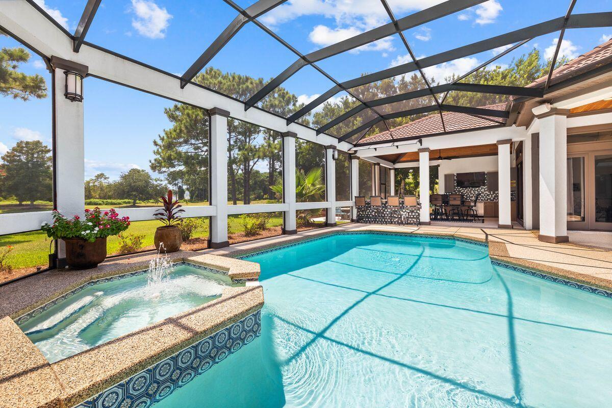 The golf course, lake, and renowned Destin sunsets are all visible from this lovely and roomy, updated three-bedroom plus office home in Regatta Bay. The list of updates is impressive, they include a new 2023 roof, an updated interior kitchen, renovated pool with new outdoor full kitchen & grilling area, exterior and interior paint, and a spectacular wine wall to name a few. A list of full improvements can be provided. This house has one of the most beautifully well-designed floor plans, which also features two living areas, two offices, an outside living area, and a covered pool, all on one level.  The residence's architectural appeal includes coastal flair and elegance, giving its owner a magnificent lakefront property with 100 feet on the lake in the exclusive gated enclave of Regatta Bay. 

You will enjoy sitting on your very own private dock feeding the turtles, dipping in to your private heated pool, and cooking and enjoying your full outdoor kitchen with bar and tv. Your spacious garage includes a golf cart to jump right in to enjoying the lifestyle of Regatta Bay. A walk up attic for additional storage is conveniently accessed with a full stairway. 

This home is being offered fully furnished including a golf cart! 

Regatta Bay is Destin luxury living at it's finest. Amenities include a 6,894-yard, par-72 course named one of Golf Digest's "Top Places to Play in North America", a clubhouse offering first-class dining, tennis courts, community large lap pool, playground, and walking paths. You will enjoy the additional private gated entrance on the North side of the community offering easy access by golf cart or car to the boating club at Legendary Marine and Yacht Club! The Destin Commons Shopping Center as well as Whole Foods are easily accessible by golf cart without ever having to get on Highway 98. The beach on Scenic Hwy 98 is just a mile away and is also accessible by golf cart! 

The community is ideally situated on the eastern end of Destin within easy reach of excellent rated schools, shopping, dining, entertainment and Caribbean-like beaches and the Emerald Green waters of the Gulf of Mexico.