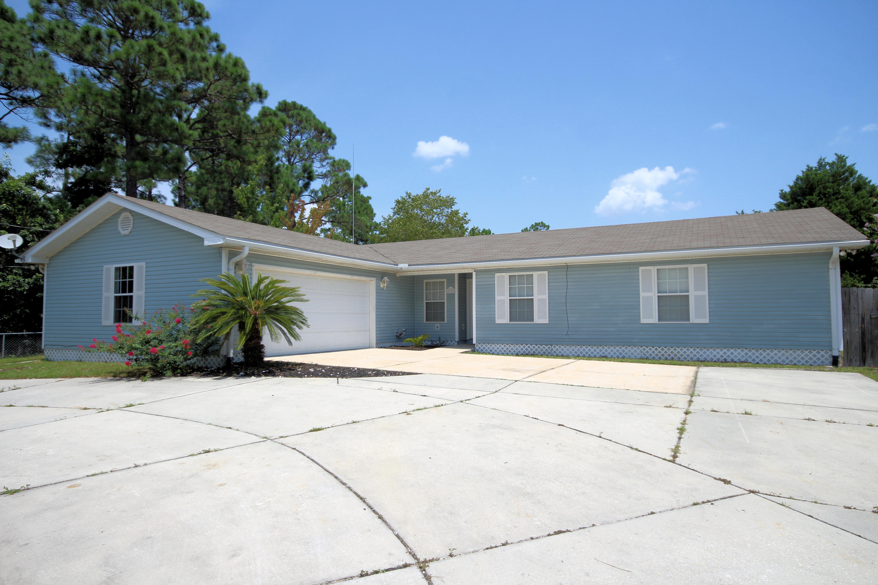 Welcome to your new home in Gulf Breeze! This lovely home sits on almost an acre of land with Deeded Access to the Santa Rosa Sound! Need some room for your projects? Boats? Extra cars? This home has all the storage you could ask for with it's wrap around drive way, detached 3-car garage, and attached 2-car garage. Don't like carpet? No problem! This home features stained polished concrete floors throughout. For those times that you want to enjoy the beautiful Florida weather, relax on your wrap-around back porch with built-in BBQ pit. This home won't last long, schedule a showing today!