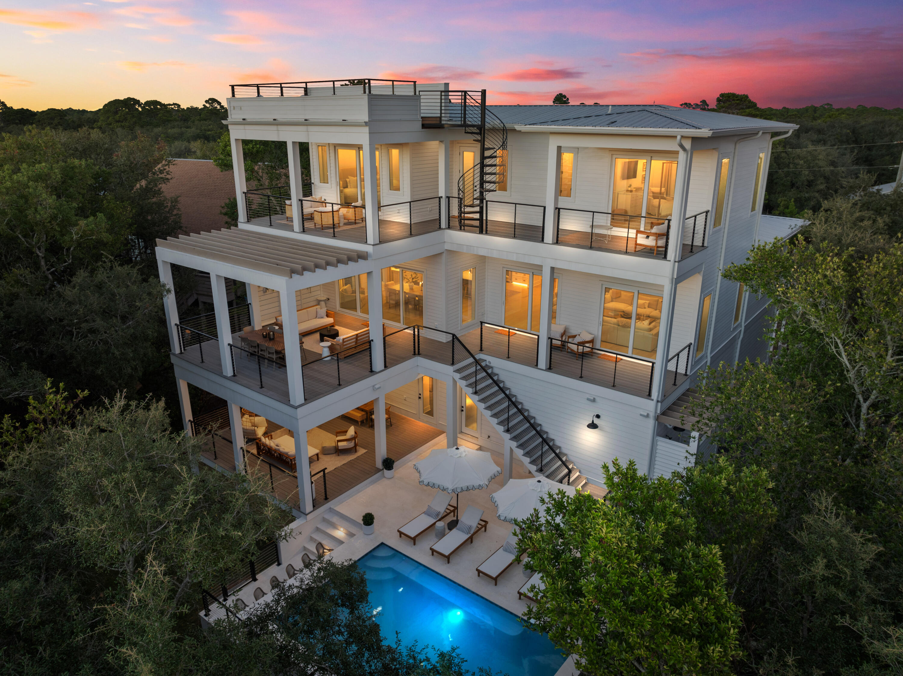 Rising gracefully at ~40 ft above sea level in the exclusive Beach Highland enclave of West 30A, this extraordinary custom estate commands breathtaking, panoramic views of the Gulf. Fully furnished and masterfully curated, this residence offers 6 bedrooms, 6 bathrooms, and 2 half baths spanning 3 levels representing a rare convergence of architectural presence, refined craftsmanship, and elevated coastal living. Perfectly positioned just a short stroll from 3 regional beach access points and the unspoiled shoreline of Topsail Hill Preserve State Park, with more than 3 miles of pristine beaches and rare coastal dune lakes, this home offers both privacy & proximity to one of 30A's most treasured natural landscapes. Designed for effortless entertaining with spectacular outdoor living spaces! Expansive balconies capture sweeping Gulf views, while the resort-style pool features in-water barstools, elevated seating for relaxed conversation, and an ambiance that rivals the finest boutique retreats. A full-service first-floor kitchen dedicated to the pool level, paired with an outdoor summer kitchen, creates a seamless setting for alfresco dining beneath the stars.

The first level offers two generously sized guest suites with private baths, a well-appointed laundry room, commercial ice machine, and a thoughtfully designed kitchen serving the outdoor entertaining areas, ideal for hosting with ease and sophistication.

Ascending to the second level reveals the heart of the home: a grand living and entertaining space designed to impress. The gourmet kitchen is outfitted with premium appliances, a spacious butler's pantry, and a custom bar, all anchored by a striking whitewashed stone accent wall. A refined dining area and light-filled living space flow effortlessly together, while a private movie theater elevates evenings at home. The primary suite on this level is a sanctuary of understated opulence, offering both privacy and elevated design.

The third floor continues the home's legacy of thoughtful luxury, featuring a custom-built bunk suite with 4 double beds and en-suite bath, an inspired retreat for guests, alongside two additional primary suites. Each enjoys access to a spacious balcony with commanding Gulf views and access to a rooftop terrace, where sunrise and sunset unfold over the treetops and turquoise horizon.

Beyond its undeniable lifestyle appeal, this estate represents a compelling investment opportunity. The property generated $221.6K in rental income in 2025 ($246k including owner bookings) and already has $157.8K on the books for 2026, with projections approaching $300K for the year. Its premier location, elevated Gulf views, expansive layout accommodating large groups, resort-style amenities, and proximity to protected natural shoreline position it as a high-demand luxury rental along Scenic 30A. For investors seeking both appreciation potential and strong cash flow, this exquisite home delivers a rare balance of prestige and performance.

Set on a generously sized homesite, the estate provides ample outdoor space for both grand-scale entertaining and tranquil relaxation. A 4-car garage, covered terrace, and expansive paver driveway ensure abundant parking and convenience. Every finish, fixture, and design detail throughout the home reflects a commitment to quality, comfort, and timeless coastal elegance.

Ideally located near some of 30A's most beloved destinations, including Stinky's Fish Camp, Shunk Gulley, Santa Rosa Beach Golf Club, Gulf Place, and more, this residence offers the perfect balance of seclusion and accessibility.

185 Dune Lane is more than a home, it is a statement of refinement and one of the most distinguished Gulf-view offerings along Scenic 30A. A rare opportunity to own a legacy property where luxury, location, and lifestyle align seamlessly.