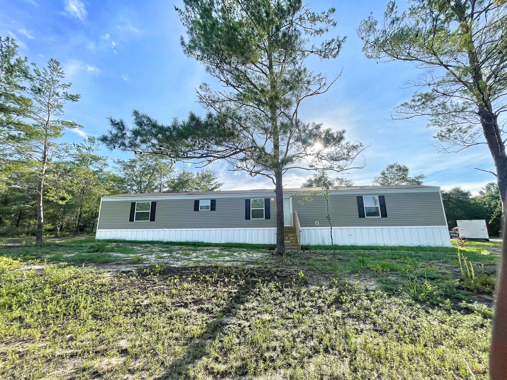 Bring all reasonable offers! Check out this 2024 Southern Energy Home 3 bedroom, 2 bath located on 1/4 acre. The seller has provided initial landscaping, crushed asphalt driveway, and paver lined walk ways. This home has an open floor plan with an office or play area outside the guest bedrooms. Great location and within 10 min to downtown DeFuniak Springs, within 10 min to I10 and short distance to the beaches, Crestview and  Eglin AFB. All measurements should be verified by buyer. Schedule your showing today!