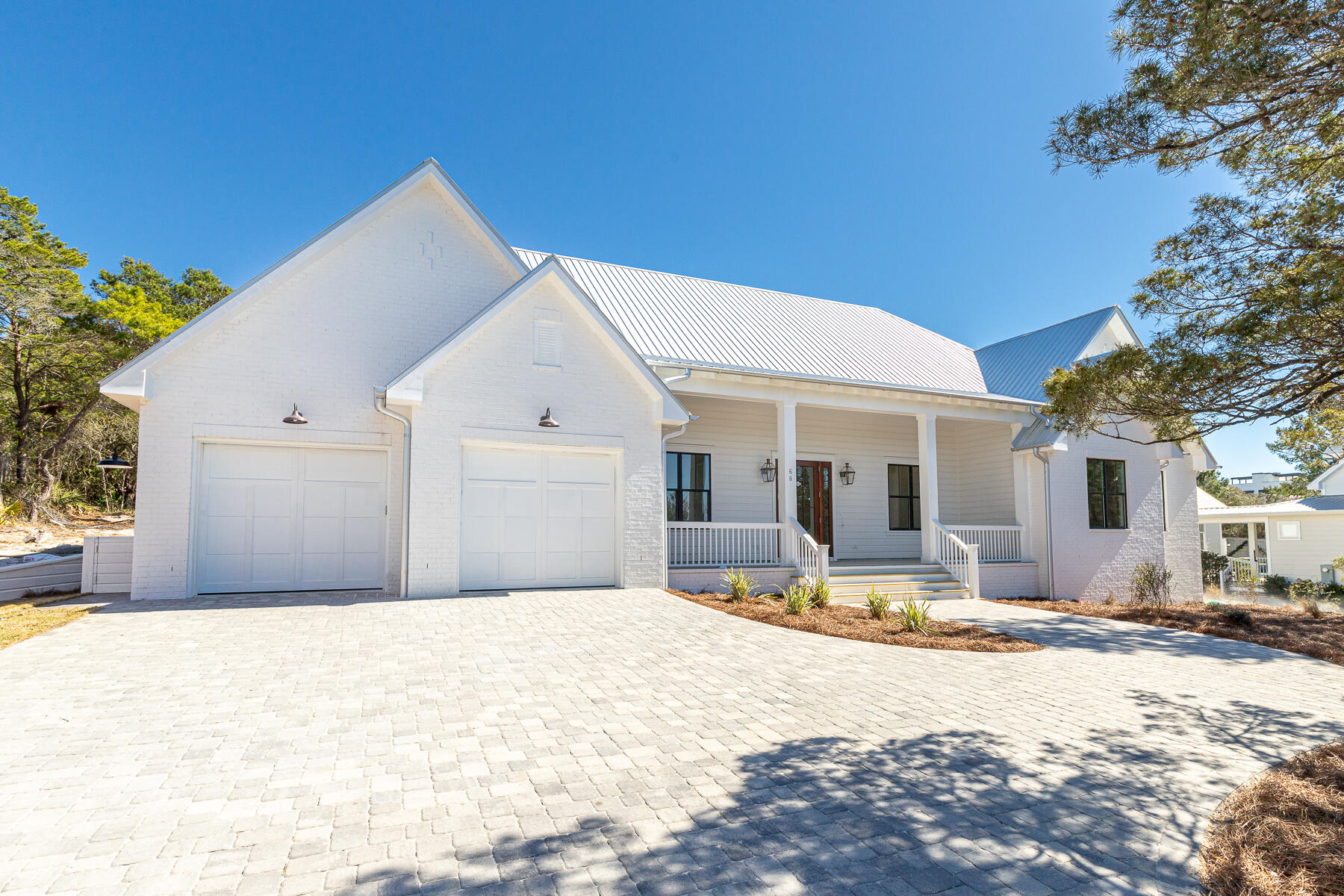 This new construction home is designed with the primary resident in mind, yet it would serve well as a second home or rental property. Completion is expected around end of this year. Built on a half-acre lot, this 3232 sqft single level home has 5 bedrooms and an office, with everything you need to enjoy life in the heart of Blue Mountain Beach. The layout and quality finishes throughout are evident as you enter through the foyer into the great room. The luxury master wing is set on the north side of the home while the 4 guest bedrooms and 4 bathrooms wrap around the great room.  A two-car garage, curated lighting and plumbing packages, shiplap accent walls, gas fireplace and gourmet kitchen with butler's pantry will delight. A carefully planned backyard offers a 24' x 12' pool with hot tub and gazebo for shaded lounging, watching ballgames, or cozying up to the fireplace. For your outdoor enjoyment, the spacious lanai with 12' ceilings, is partially screened for grilling and dining while ceiling fans provide that extra breeze. Should you ever want to leave your home, there are several public beach accesses available within half a mile as well as nearby restaurants, health food grocery store, bakery, live music at Redfish Taco as well as shops, art galleries, the bike path on Scenic Hwy 30A and State Forest Trails.