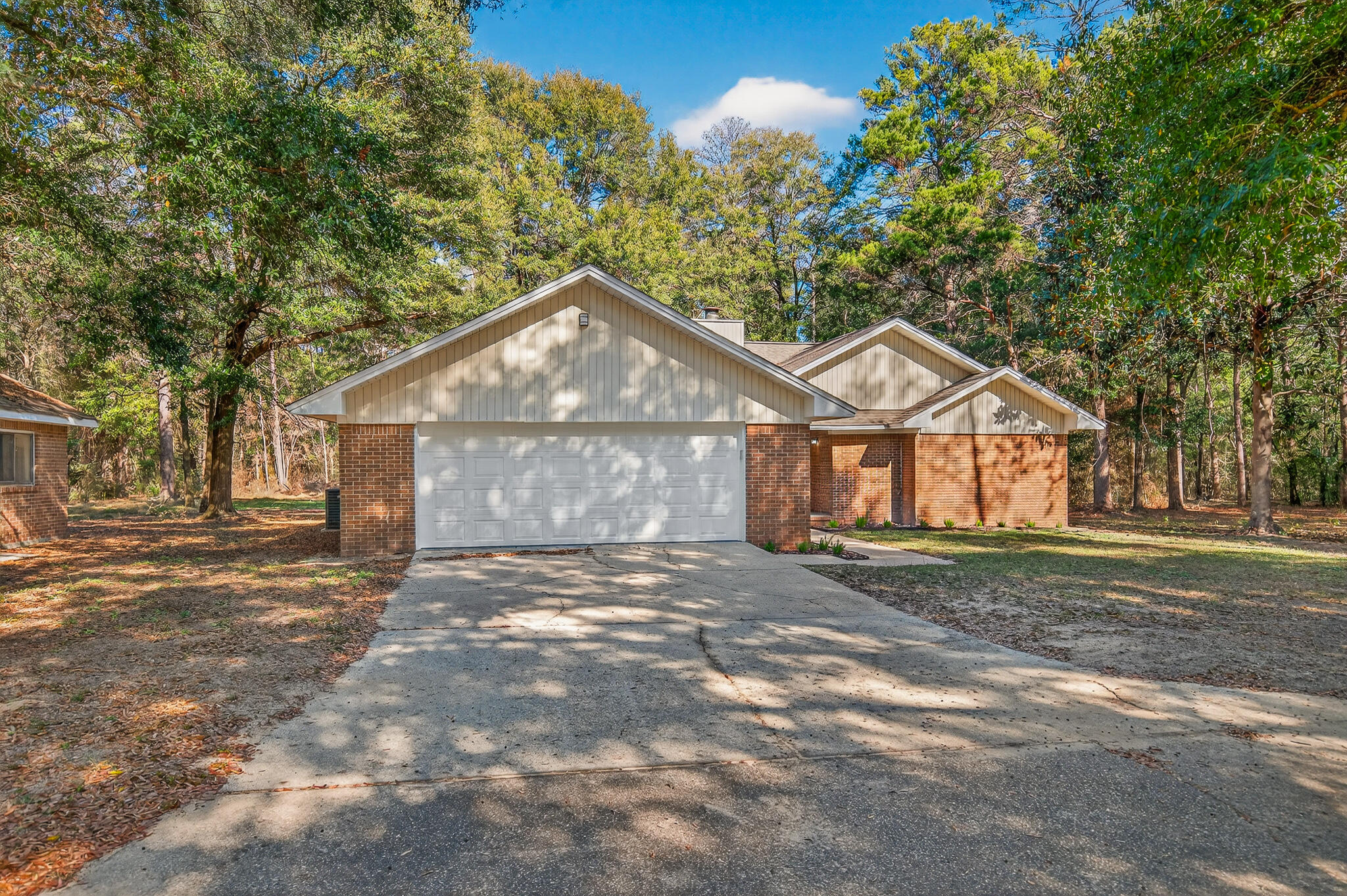 Welcome to your private retreat in Crestview. Situated on 4.5 acres in a quiet rural setting, this 3-bedroom, 2.5-bath brick home offers space, privacy, and comfort. A large circular driveway provides ample parking and leads to a 2-car garage. Inside, the spacious great room features vaulted ceilings, a cozy fireplace, and an abundance of picture windows that frame peaceful wooded views and fill the home with natural light. The updated kitchen boasts butcher block countertops and new stainless steel appliances, perfect for both everyday living and entertaining.
The primary suite is generously sized and includes a walk-in closet and an oversized walk-in shower. Step outside to the large back patio, ideal for relaxing, grilling, or enjoying the serene surroundings. Additional highlights include a brand-new roof and a layout designed for both privacy and functionality. A rare opportunity to enjoy country living while remaining convenient to town.