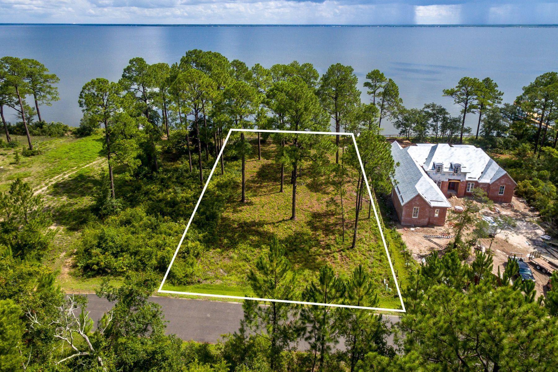 Your boating lifestyle awaits you with this spacious home site that delivers waterfront living in the home design of your dreams. Experience the bay breeze from your front porch, slip into your private pool, add your own dock, and landscaping to create a personal sanctuary. Seclusion Bay is a private, gated community with No Build Out Time Frame, only 53 estate sized lots, and modest association fees of $50 per month. This lot is just under half an acre with seawall shoreline protection and is in Flood Zone X, a rare status for bay front homes. Fifteen acres of preservation in the neighborhood provide natural surroundings and exceptional bird watching, with visits from osprey and even bald eagles. Within minutes you can be on the beach or be enjoying good eats at top notch restaurants. The Emerald Coast of Florida is famous for fishing in the Choctawhatchee Bay and the Gulf of Mexico, accessed through the East Pass in Destin or the Intercoastal Waterway in Panama City. A survey is available.