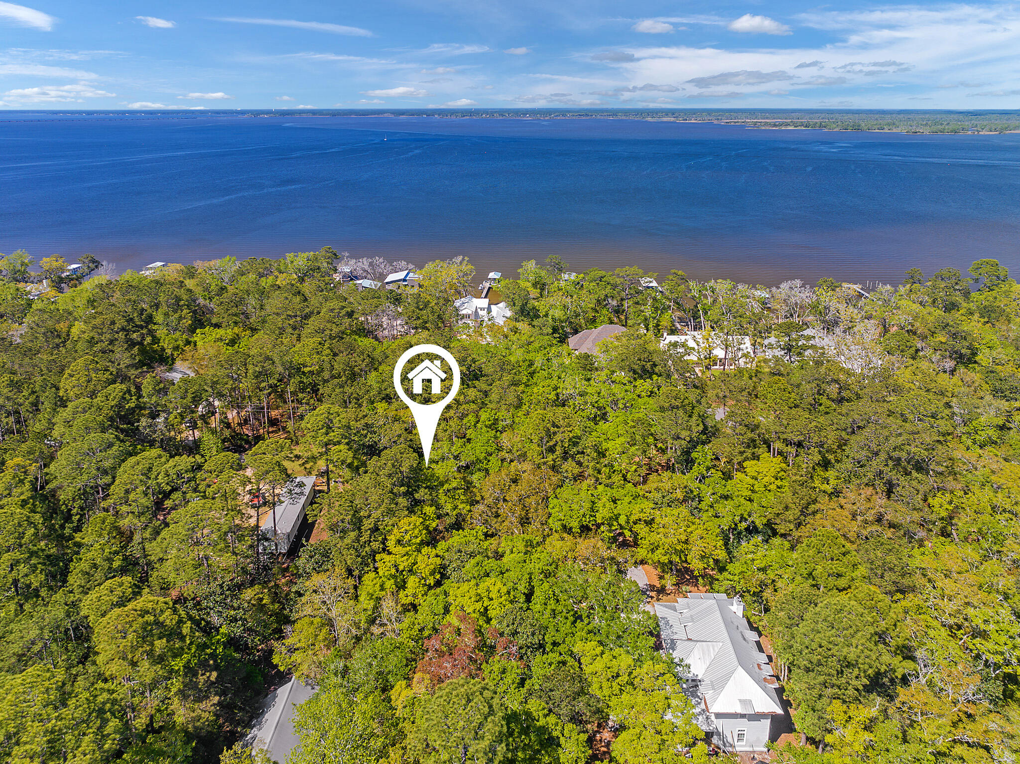 Double Corner Lot! With a perfect position in Magnolia Beach community on the Choctawhatchee Bay, this Daisy Drive double lot offers highly coveted Bay views of endless blue-green water to the east and west along with the perfect elevation for building a dream Bayfront magnum opus residence. Magnolia Beach is a much sought-after neighborhood in the heart of Point Washington State Forest with no HOA and easy access to the Bay lifestyle with boating, fishing and paddleboarding from the community boat launch area located within walking distance.  In addition, this spacious 50x150 foot lot is less than 5 minutes from Grayton Beach and 30A with its eclectic menagerie of dining and entertainment options. Special Note: Mobile homes are not permitted due to Deed restrictions.