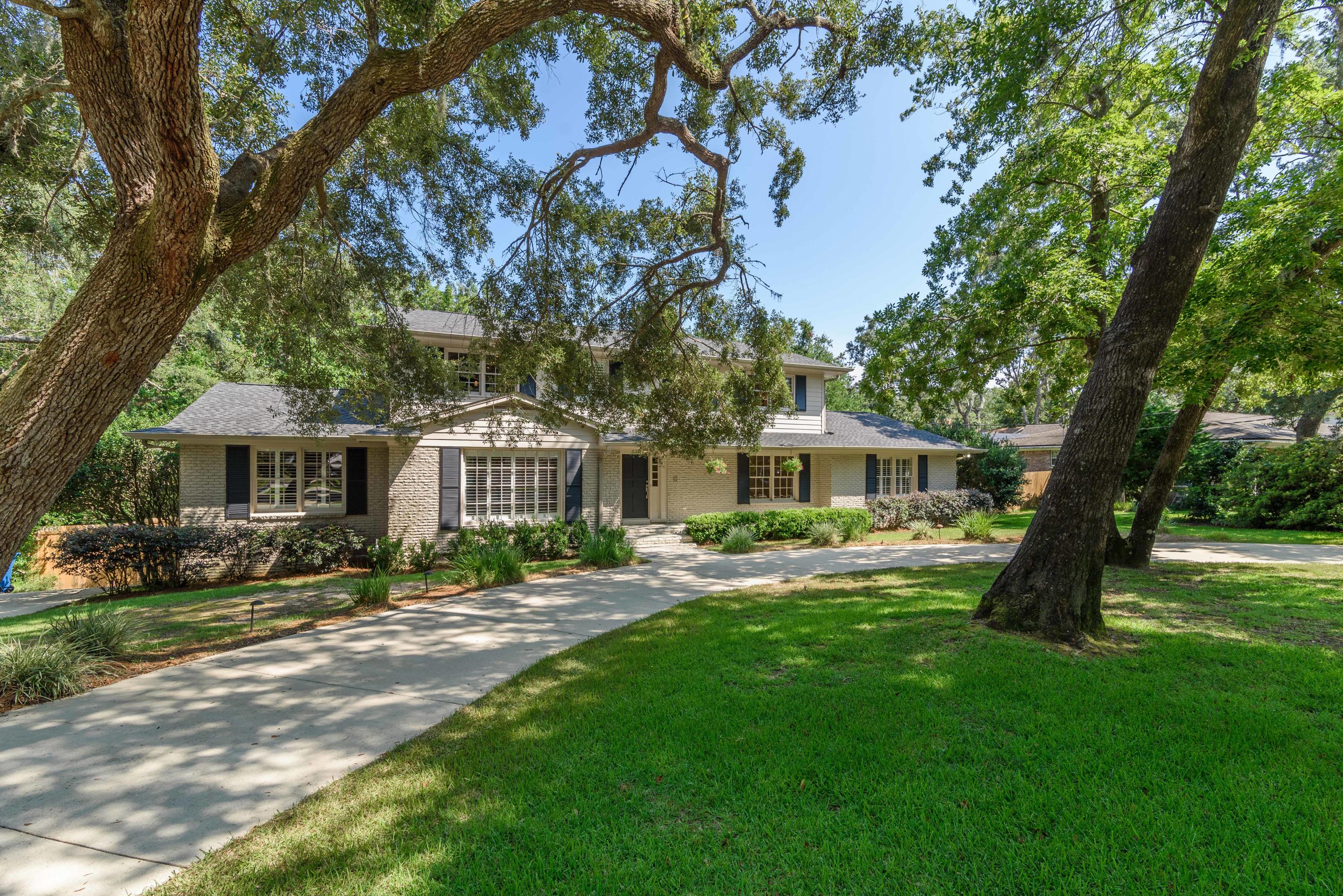 Located in the heart of Gulf Breeze Proper in the established neighborhood of Northcliffe, this stately home offers lush mature landscaping with majestic Oaks, gunite pool, gorgeous kitchen with an open spacious floor plan and two living spaces. You'll enjoy the stunning hardwood floors throughout the main living space and a spacious dining area suitable for a table with service for 10. The second living space has a fireplace, walk-in closet and exterior door to the pool. Just off the living space is a bedroom with a full bathroom. There is an additional bedroom or library off the living area and a bonus space that would make for a prefect office. This entire wing makes a perfect In-Law suite. The kitchen comes equipped with unique granite counter tops, custom cabinetry with soft close dra Located in the heart of Gulf Breeze Proper in the established neighborhood of Northcliffe, this stately home offers lush mature landscaping with majestic Oaks, gunite pool, gorgeous kitchen with an open spacious floor plan and two living spaces. You'll enjoy the stunning hardwood floors throughout the main living space and a spacious dining area suitable for a table with service for 10. The second living space has a fireplace, walk-in closet and exterior door to the pool. Just off the living space is a bedroom with an en-suite bathroom. There is an additional bedroom or library off the living area and a bonus space that would make for a prefect office. This entire wing makes a perfect In-Law suite. The kitchen comes equipped with unique granite counter tops, custom cabinetry with soft close drawers and abundant storage, gas stove with dual ovens, under cabinet lighting and large island with a prep sink. The primary suite is located on the second floor with 2 additional bedrooms and full bathroom. The enormous primary suite has an additional designated sitting area suitable for a desk or Peloton. The bathroom has a double granite vanity with 2 walk-in closets and additional custom cabinets for closet space. The custom shower has dual shower heads and a bench with beautiful mosaic accents and flooring. The exterior has wonderful landscape lighting with a circular drive, side parking pad with a double gate ideal for boat storage. The expansive back yard offers a pool with a tiled open lanai and a playground. Located just half a mile to Gulf Breeze Elementary, Middle and High School, 3 miles to Pensacola Beach and 6 miles to Downtown Pensacola. This location cannot be beat. Check out our full video tour on the MLS and YouTube.