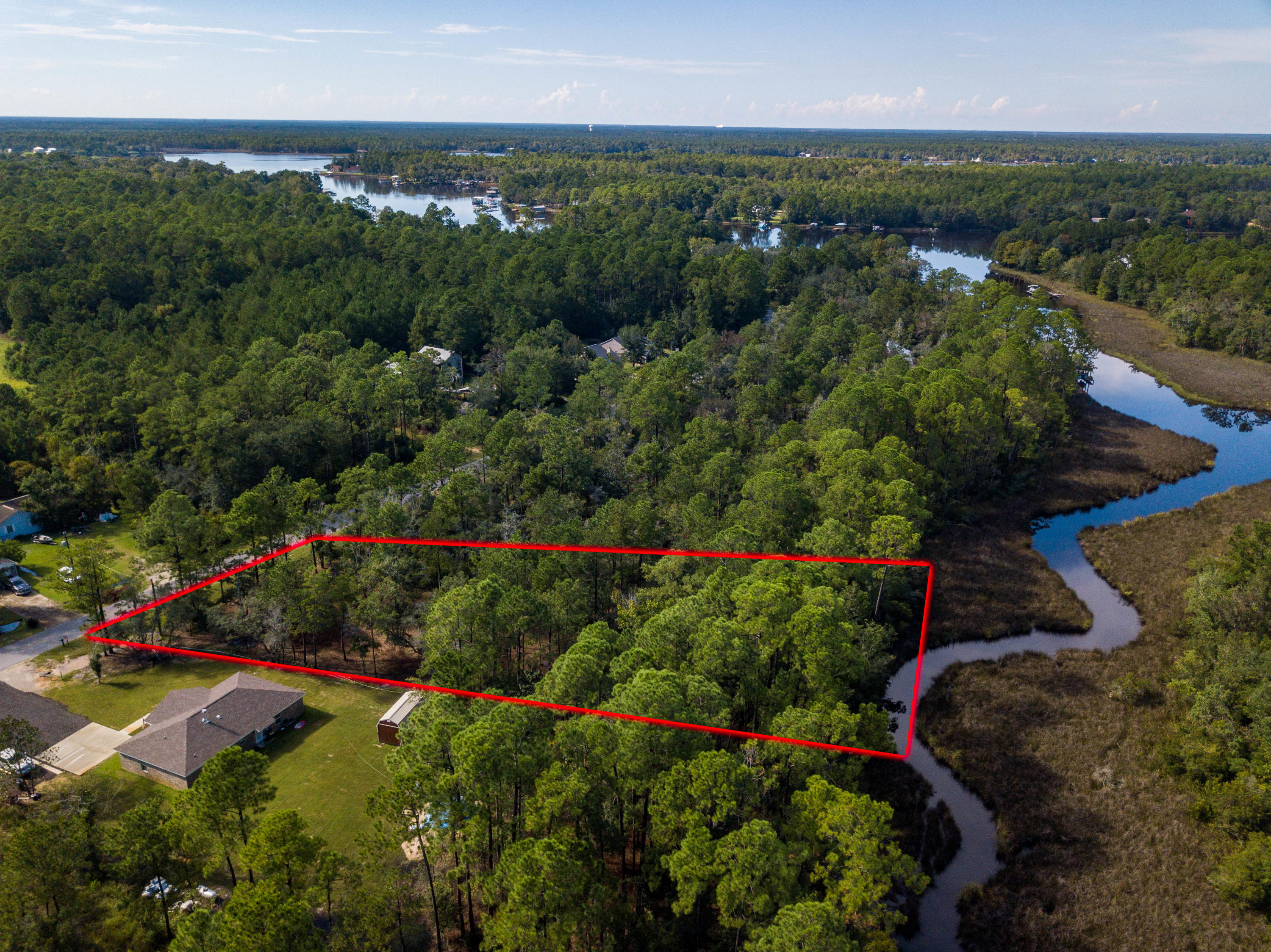 Very nice building lot just a little over a half acre with 99 feet of shallow water frontage on Mallet Bayou Reach. Paved road frontage of 90 feet and only minutes from the beaches of South Walton. No build-out time requirement and no HOA. Beautiful homesite with nice homes in the area.