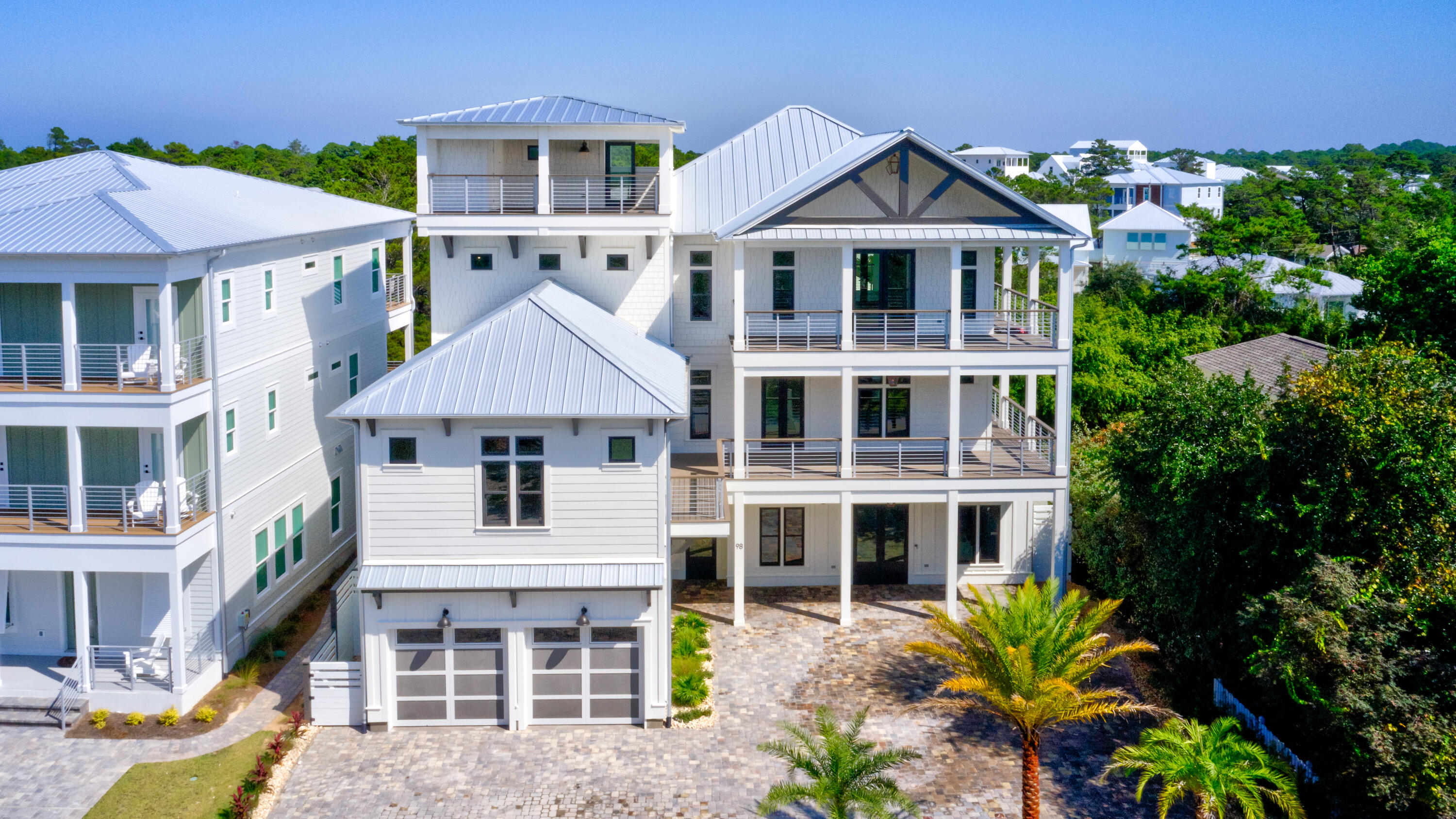 The Beach Escape truly holds up to its name. This exquisite property exceeds all expectations, whether full time, second home, or vacation property. This home has all the amenities of a coastal vacation and within a few minutes to three beach accesses. This four story  Coastal Beach House hosts beautiful porches and walkover to carriage house. The fourth floor lets you gaze at breathtaking gulf views and amazing sunsets. This property offers spacious room for living or vacation rental with seven bedrooms including full bunk room, gourmet kitchen, gas range, wet bar, wine cooler, and pot filler. Perfect for entertaining. The dining and living area with its Euro doors opens up to a large covered lanai. Enter into a resort style pool with hot tub , waterfall, and fire pods. Outdoor kitchen