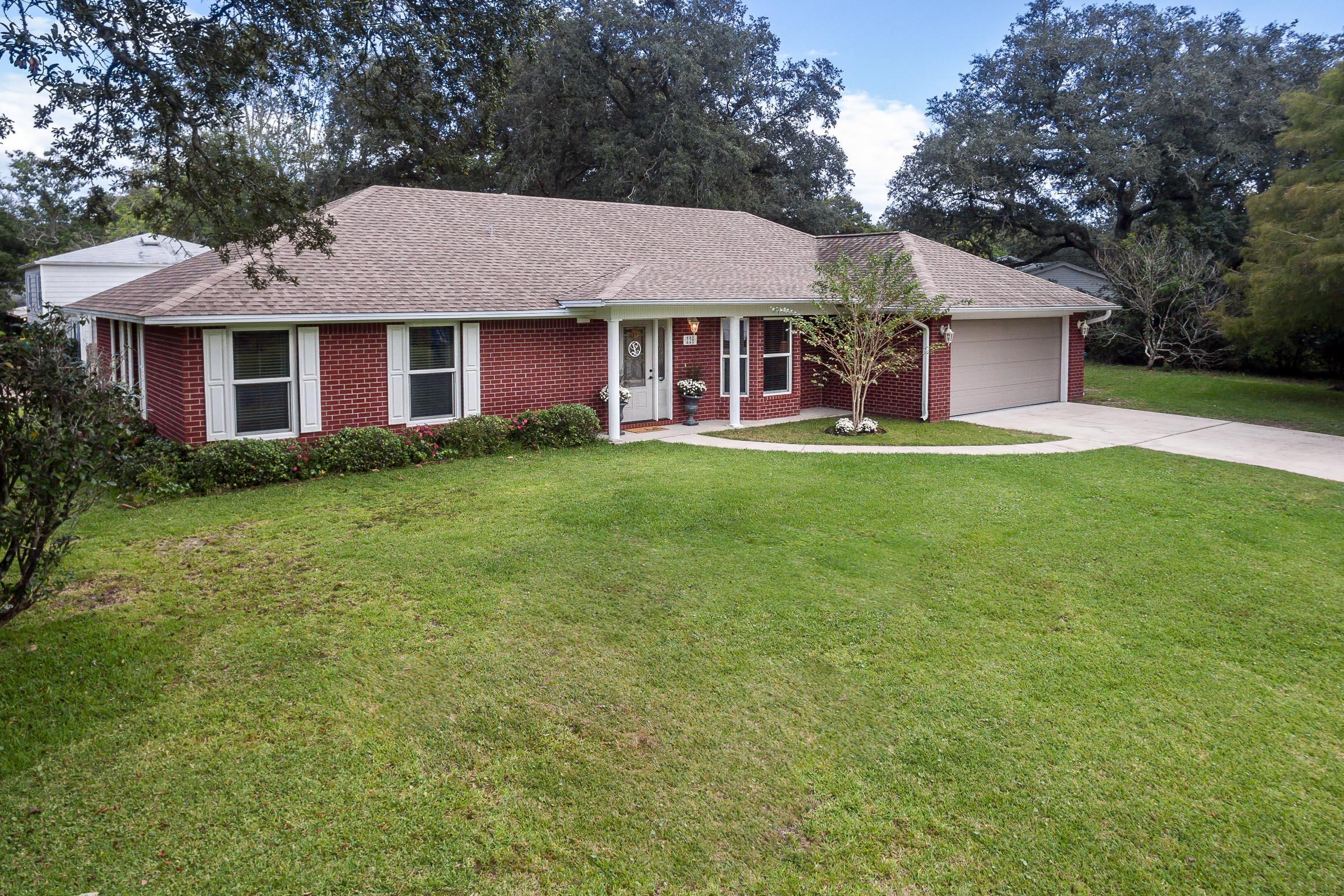 This beautiful red brick house was built in 2008 and, as such, features a more modern floor plan and amenities in the well established neighborhood of Colony Estates. An open concept floorplan, this home was renovated in 2015 with new floors in the common areas, new granite in the kitchen and media room, new stainless steel appliances, a completely redone guest bathroom and the addition of a new large poured concrete patio in the backyard. The large, corner lot boasts just over a quarter-acre of land with ample room for entertainment and features both an orange tree and lemon tree.
