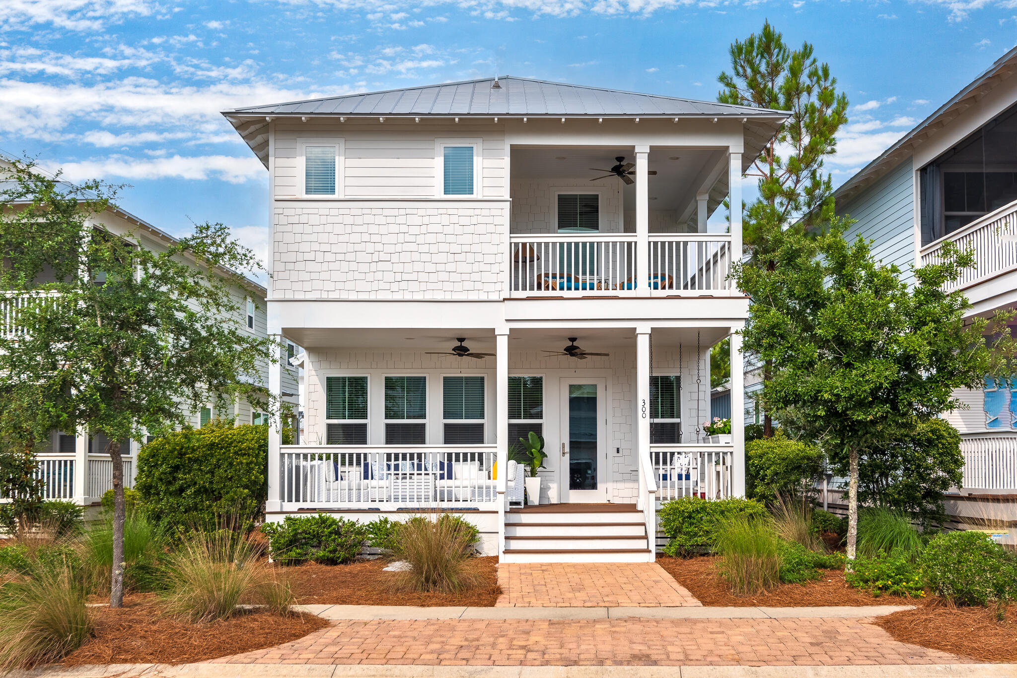 Experience the coastal lifestyle you deserve in this fully furnished, never rented, 4-bedroom + loft beach house located in the amenity-rich NatureWalk at Seagrove community. With exclusive access to NatureWalk's ''Gathering Place'', featuring a zero-entry pool, heated lap pool, childrens' pool, hot tub, playground, and much more, you can indulge in 30A living. There is even a trail to the beach! Ideally located near the pickleball courts, this immaculate home has a rare one-car garage, oversized parking pad that can fit 3-4 vehicles, and 1 unassigned space out front. With two primary suites, two covered porches (freshly painted), loft space for bunks, an expanded dining room, tons of natural light, and upgrades galore, it will make the perfect full-time residence or profitable vacation home. Short term rental projections are up to $110,000 per year! The gourmet kitchen includes built-in stainless-steel GE-Cafe appliances with gas cooktop, designer pendant lighting, and a custom built-in wine cooler with cabinetry. The first-floor primary suite has two closets and an en suite with double vanity, garden tub and tiled shower. Upstairs there are three bedrooms and a loft that would make the perfect office, bunk space, or additional living area. The second-floor primary suite features a covered porch and has an en suite with a free-standing tub and tiled shower. Additional features include oak floors, 10 ft ceilings, custom closet shelving, real wood blinds, 6-stage Alkaline water filtration system, built-in ironing board, sonos speakers throughout the house, porch fire pit and bed swing, outdoor shower, gas grill that is connected to natural gas, irrigation, Lockly electronic lock with fingerprint entry, and more closet space than you will ever need! This home is offered turnkey and includes a golf cart (two options to choose from), electric bikes with built-in garage charging stations, golf simulator, bike pulley storage system for additional bikes, shelves with rafter storage, paddleboards, beach chairs, umbrellas with built-in storage organizer rack, and garage refrigerator with freezer. This sought-after neighborhood in Seagrove Beach is a nature enthusiast's dream and enjoys easy access to 30A's sugar-white sand beaches, coastal dune lakes, and Point Washington State Forest. Head to the beach, paddleboard on one of the coastal dune lakes, or enjoy biking/hiking on miles of trails. Other community amenities include multi-purpose courts, energy fitness stations, and amazing trails throughout the neighborhood that also connect to state forest and the beach. It is also conveniently located next to WaterColor Crossings shopping center that has the only Publix on 30A along with other shops and restaurants. Seagrove Beach is centrally located on 30A and has more public beach access points than any other 30A community. This makes it the perfect place to indulge in beach activities, from playing in the sun to enjoying beach bonfires at sunset.  Contact us today to schedule a showing!