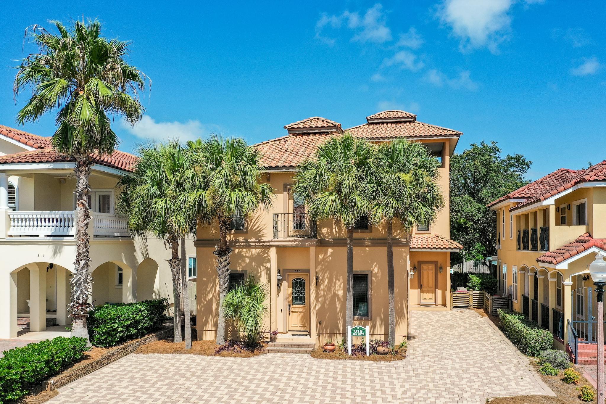 Incredible fully furnished 4 bedroom, 5.5 bath home located in the beautiful  Mediterranean gated community of La Valencia just across the street from the Gulf of Mexico on the desirable west end of Panama City Beach. This home boasts stunning Gulf views from the upper level and offers elegant features including travertine floors, 12 ft. ceilings and a gourmet kitchen with granite countertops & stainless steel appliances. The main home has two master suites with one conveniently being on the first level. Enjoy Gulf views from the covered deck on the top level, which is perfect for entertaining & watching the sunset. There is a paver stone back patio ideal for outdoor dining & grilling. A unique feature of this property is the attached guest quarters, maximizing rental income. The guest quarters is even equipped with its own kitchen and two full baths. This split floor plan allows guests to have added privacy. For the main home, each master bedroom offers a luxurious en-suite master bathroom with double vanity, granite countertops, Jacuzzi tub to unwind in after a day at the beach, tiled walk-in shower and a walk-in "California" closet of course! There is beautiful craftsmanship throughout with white stained wood detailing, crown molding and 8 foot solid wood interior doors. The gourmet kitchen has a gas range suited for a chef, hood, full sized fridge & freezer and a separate wine fridge and ice machine. There are plentiful cabinets, a breakfast bar great for casual dining and an open dining area. There is a half bath downstairs and a separate laundry room with a full size washer & dryer and storage. The top floor entertainment balcony is sure to impress with the expansive open air concept enhancing the Gulf views and tropical setting. Not only do you have a deeded beach access for the community but also a Gulf front pool to enjoy while at the beach. When you are hanging out by the house there is an additional pool, hot tub and clubhouse with a fitness room on the north side as well as tennis courts. The curb appeal is exceptional with tropical landscaping and a paver stone driveway. The subdivision is nicely maintained by the HOA and is a great community. Prime location on the west end of Panama City Beach close to Pier Park and prestigious communities of 30A (just under 6 miles away). Enjoy beach living and the coastal lifestyle everyone desires!