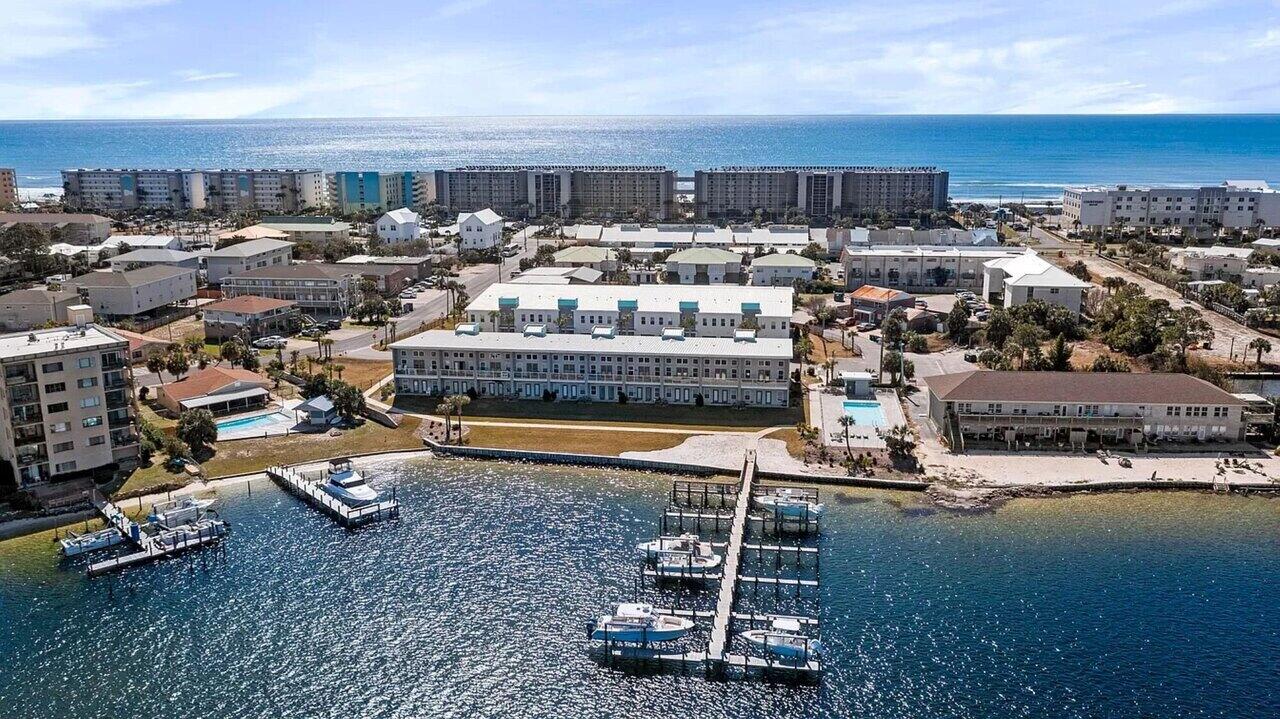 Check out this awesome immaculately kept waterfront townhome in the highly desired Soundside Lofts community on Okaloosa Island. 
This 3BR/3BA + bunk room home offers unobstructed Sound views and its own deep-water boat slip with a 12,000 lb lift accommodating boats up to 32 ft. Features include luxury vinyl plank flooring throughout, custom closet shelving, 5-panel doors, shaker cabinets, craftsman trim, and impact-rated windows and doors. 
The kitchen boasts stainless steel appliances, granite countertops, and stunning water views from both levels. Community amenities include a pool with sundeck and a private dog park. Located just a 3-5 minute walk to the white-sand beaches of the Emerald Coast and a short boat ride to Destin Harbor and Crab Island. Turn-key and ideal for a primary residence, second home, or investment property. Schedule your showing today