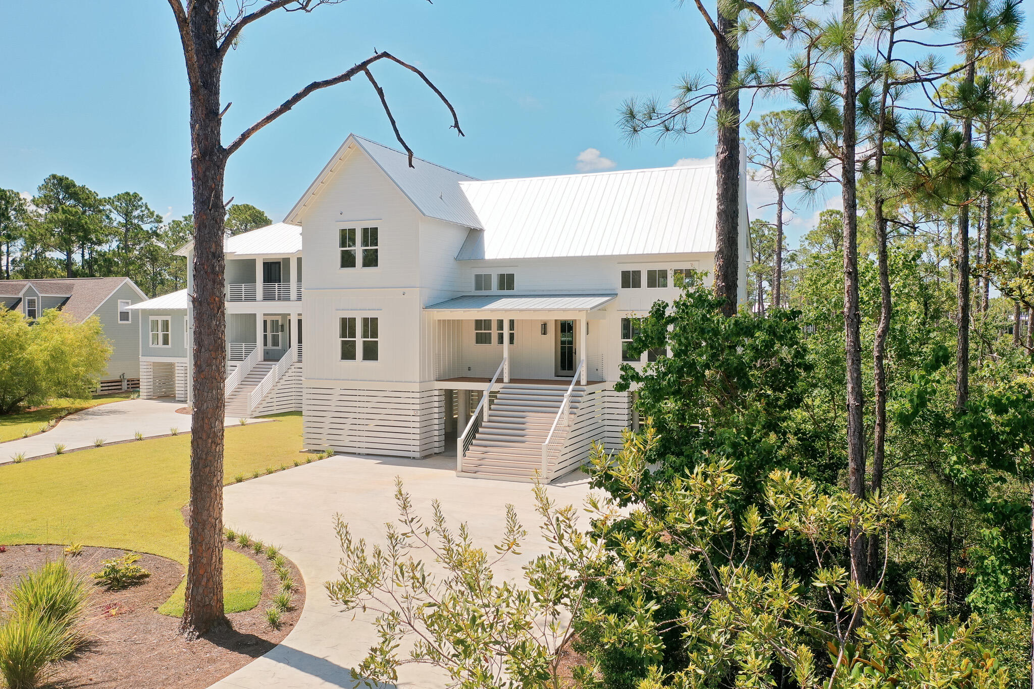 Discover waterfront living at its finest with this stunning new construction home nestled on a generous lot featuring a private dock and boat lift. This exceptional home combines elegant coastal design with modern functionality and breathtaking views.

Step inside to a grand entry that immediately impresses with soaring cathedral ceilings, custom chandeliers, and expansive windows that flood the space with natural light. The open-concept layout seamlessly connects the living area to the kitchen, centered around a sleek electric fireplace and designed to maximize both comfort and style. The heart of the home is the chef's kitchen, featuring a large island with a waterfall-edge quartz countertop, a six-burner gas stove with custom wood range hood, stainless steel appliances, and neutral wood finishes and flooring carried throughout the home. A cozy dining area sits just off the kitchen, offering uninterrupted views of the water.

Extend your entertaining outdoors and catch a salty breeze on the covered balcony with beautifully detailed wood ceilings and modern cable railings that ensure the view remains the focal point.

The main-level primary suite is a true retreat with serene water views from the moment you arise from your bed and a luxurious ensuite bath that includes dual vanities, a walk-in glass-enclosed shower, custom lighting, and a deep soaking tub that elegantly separates the vanity spaces. A spacious walk-in closet with custom wood shelving completes the suite.

In addition, the main level is a secondary bedroom with its own ensuite featuring a tub plus shower combo-perfect for guests.

Upstairs, you'll find two additional guest bedrooms, each with private ensuites, as well as a flexible bonus room ideal for a home office or study, complete with its own half bath.

The expansive lot offers limitless possibilities-whether you envision adding a pool, putting green, or creating your own outdoor oasis, the space is there to make it a reality. Ideally located just minutes from iconic 30A and only 10 minutes to Sandestin, you'll enjoy easy access to local shops, acclaimed restaurants, year-round festivals, and the sugar-white sands of the Gulf. Spend your days boating right from your backyard into the Bayou and Bay or unwind with a sunset cruise after a day at work-this is coastal living at its best.