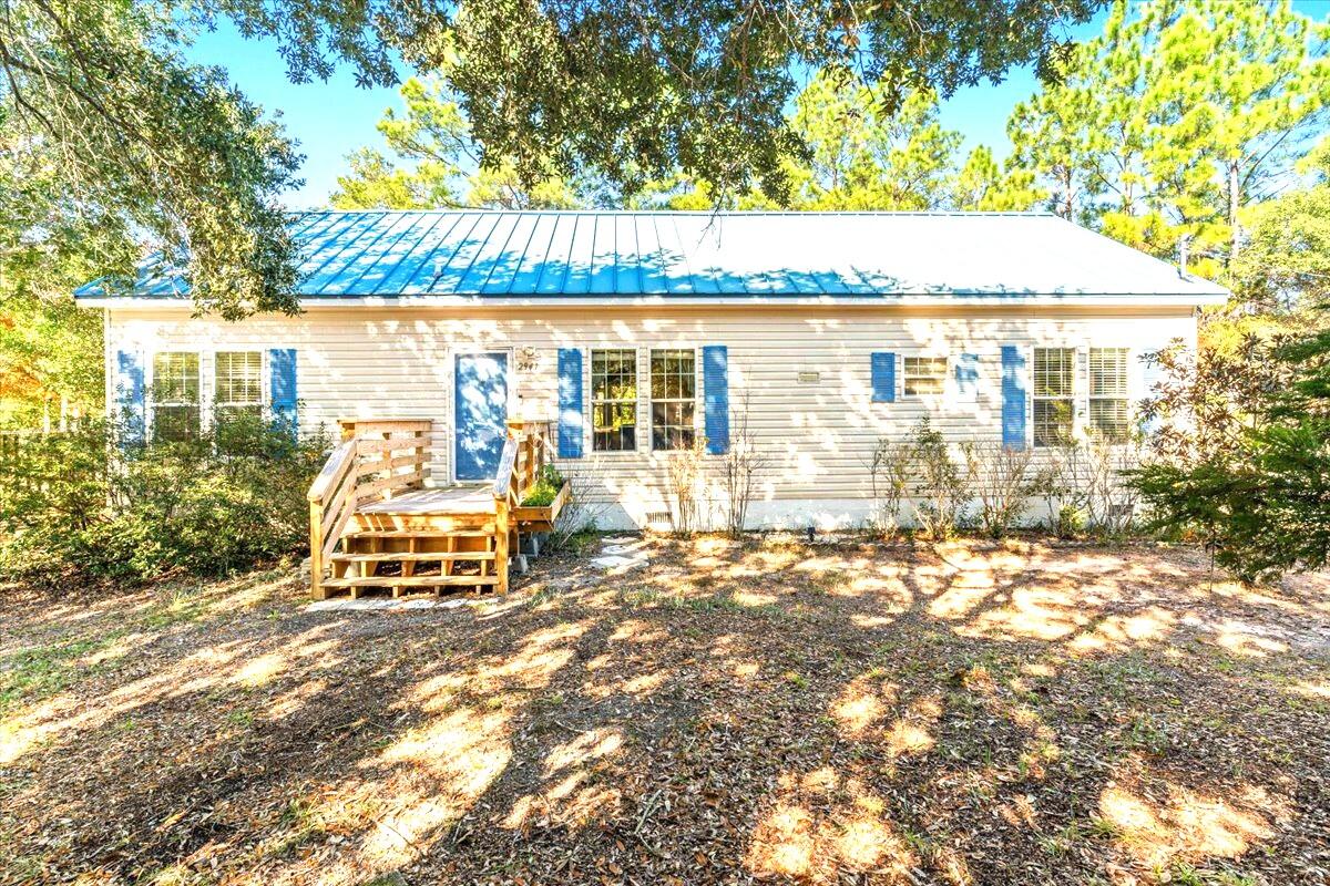 Here it is, the home you've been looking for, right here in Navarre! Landscaped for privacy, this well-kept home has two decks, a screened in back patio, an arbor for your climbing plants to grow and a handmade seating area for watching the birds and squirrels snack from your feeders. Inside you'll find a galley kitchen wide enough for multiple cooks at once and plenty of room for in kitchen dining. The expansive living area separates the bedrooms in this split floor plan, providing lots of privacy for the large primary suite! The primary bathroom features a jet tub with separate shower and a double vanity. Take your morning coffee out onto the spacious screened in porch without waking the rest of the house by sliding through the private entrance. This is your escape from the daily grind Looking for the rest of your household? Simply stroll through the living room to the hallway, past the shared full bathroom, and find the two ample sized bedrooms with their own walk-in closets. This well-maintained home has crown molding throughout, faux-wood blinds, and ceiling fans in all the bedrooms and living room, plus the comfort of carpet in the main living areas and bedrooms. The metal roof provides years of worry-free protection. Ready to move in? Call your realtor for an appointment today!