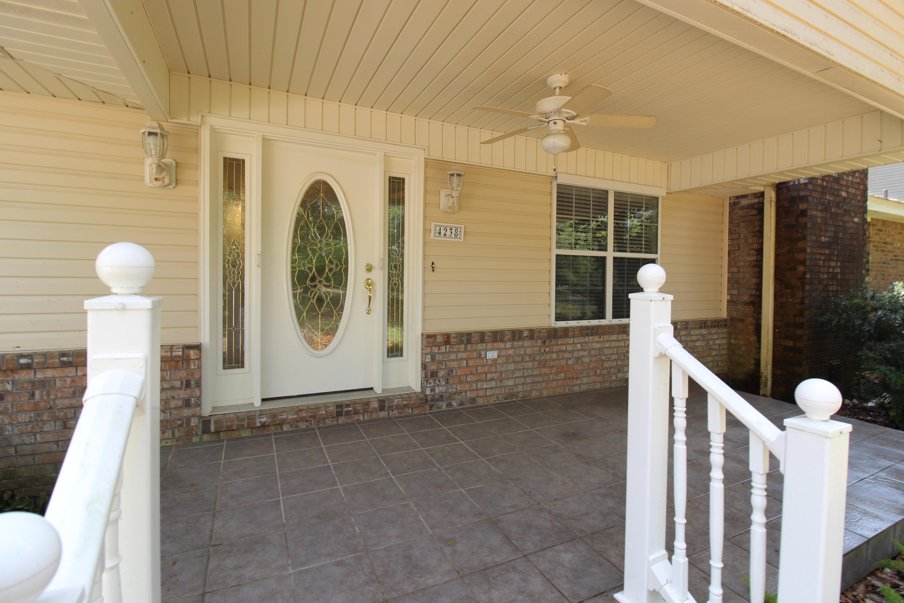 The renovation and additions to this sturdy home where completed in 2001 and the screen enclosure porch in 2007. As you approach the home, you will be delighted by the natural landscaping and round about gravel driveway leading back to the home. Mature Magnolias and Oak tress provide canopies of shade on this .62 acre home front. Sidewalk to the side entry garage where you will find a work area and storage closets. Enter the home from the paver sidewalk to through the large front covered porch. Step into the roomy foyer and you'll admire the living room and dining area there is a swinging door to the Kitchen and French doors to the Grand family room, where you can also have an additional dining area and plenty of room for a pool table or media room which leads you back through.. continue to the Kitchen. Boasting a double oven, smooth glass drop in electric stove top and elevated counter tops. The Dishwasher has also been elevated so you won't stain your back when time to empty it. Plenty of Oak Cabinets and a bright white Corian counter tops. The garden window above the sink will provide a nice place for your herb garden. Just off the kitchen is a wet room/drop zone with plenty of cabinets for storage, utility sink and more counter space which has a entry way to the garage.  Back through the living room there is a hall with a half bath. through here you'll walk into the den with a beautiful white brick fireplace, recess lightening. To your left you'll pass through to the Master suite. The Master bathroom has decorative tile floors, vanity and a large walk in shower with bench and multiple shower heads and is equipped with handlebars and glass shower doors. The Master Bedroom has a large walk in closet with custom shelving and draws. Skylights provide lots of natural light. Just off the Master bedroom is the Laundry Room which features more storage cabinets and counter tops with access to the pull-down stairs to attic and an exit door to the small covered porch and stairs to the back yard as a bonus. Back through to the den there is a hallway featuring a full bath providing use for the additional three large bedrooms of the home. Each with nice size closets. Relax on the screen in porch off the other side of this wonderful home and admire the wonderful sounds of nature and privacy. There is a deep well that feeds from a 400 ft aquifer, so you always have plenty of "free" water. Sprinkler system runs throughout the grounds. The HVAC system was updated in 2015, Roof Replaced in 2014. There is a 20KW whole house generator installed in 2012. This Home has no carpet, there is oak flooring through out and ceramic tile.