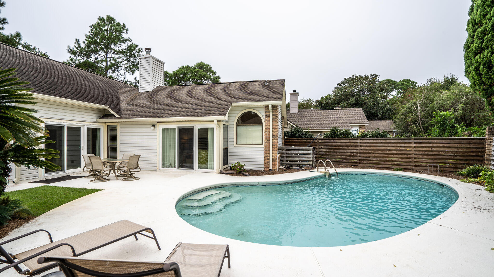 This wonderful  one level home, with a two car garage is located in a rental restricted neighborhood.  It has a large backyard and  a wonderful POOL for outdoor fun and entertaining.  It is being sold totally FURNISHED and conveys with a 4 seater GOLF CART. A combined living and dining area, with a gas fireplace and sound system make a great place for family and friends to gather.  A large master bedroom, which opens to the pool, has two walk-in closets and the adjoining bath has double vanities, granite countertops, a separate shower and garden tub.  You will find granite countertops in the kitchen with all stainless steel appliances.  A new roof was added in 2014.  This home located in a great neighborhood is move in ready for a permanent or vacation home.