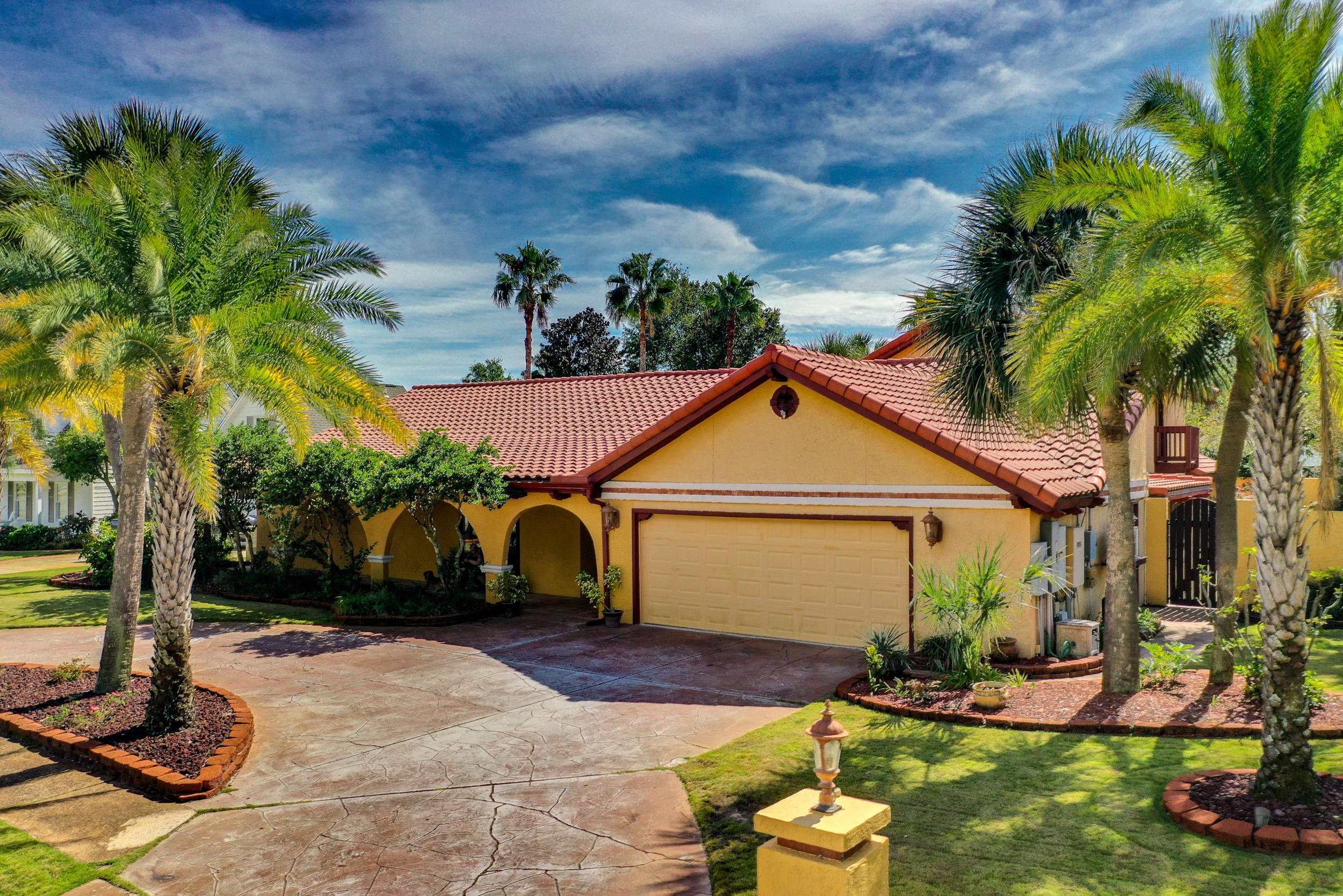 Prepare to be swept away by this authentic,totally private, two-story Spanish hacienda with more than 4,000 SF of living space. On over 1/4 acre, this is a truly special home, blending romantic old world charm with newer modern, top of the line amenities, appliances & most notably its own entertainment room with overhead HD projector plus 10' screen, pool table, dart board, bar, and much more. Throughout the residence you will discover the warmth & charm that only an original Spanish home can offer with copper buttoned ceilings, faux paint, arched doorways, open beamed ceilings, carpeted bedrooms, and hardwood/ tile floors throughout. The floor plan provides a private setting surrounding an oversized outdoor pool, jacuzzi, koi pond, and outdoor patio with a built-in kitchen containing a 50" grill with a rotisserie setup, two burner stovetop, low set two ring burner ideal for a crab boil, and refrigerator. Inside offers two wood burning fireplaces, a family/living room combination, sauna, formal dining room, and a variety of rooms to decorate as desired. The home has a Generac generator system that can power the entire home, 4 AC units, two car garage with terrazzo floor and cabinets galore for storage! Do not miss the opportunity to purchase this fantastic home!