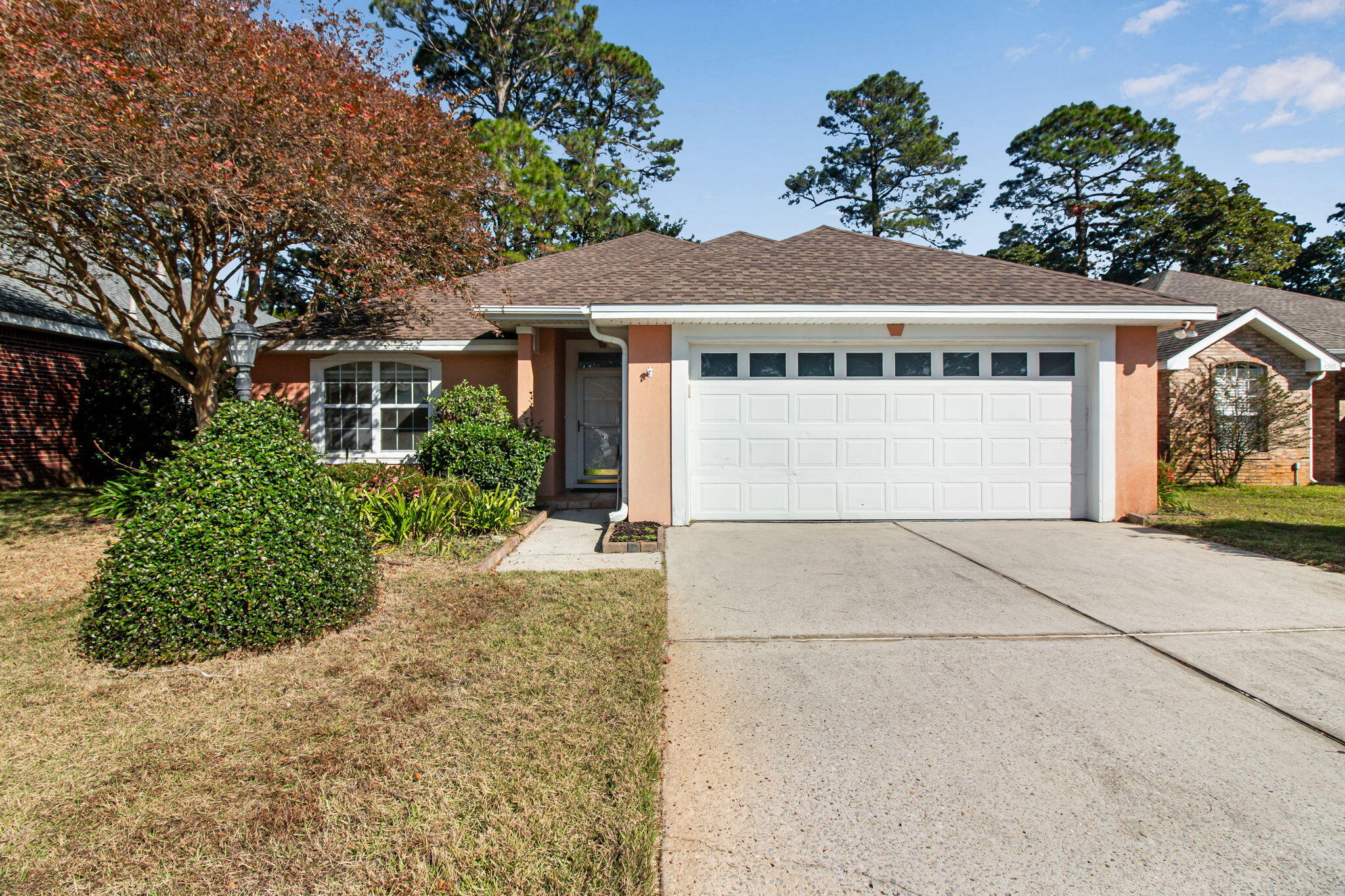 Back on market due to NO fault of seller!! This meticulously maintained 3-bedroom, 2-bath, 2-car garage home offers comfort, style, and convenience; plus a new roof and new water heater for added peace of mind. Ideally situated just minutes from the white-sand beaches of the Emerald Coast, this property blends everyday functionality with coastal living. The bright, open layout features a spacious kitchen with solid-surface countertops, a breakfast bar, and tile flooring. An oversized pantry has tons of storage. The utility room includes a washer and dryer. Vaulted ceilings enhance the dining and living areas, complemented by crown molding, built-in bookcases flanking the fireplace, and tubular skylights that fill the home with natural light.  A termite bond in place can be transferred. Additional features include hurricane shutters, a lawn pump and sprinkler system, and a termite bond for added protection. Enjoy year-round relaxation in the Florida room or entertain outdoors on the open patio. The backyard backs up to the Preserve Disc Golf Course with walking paths, creating a peaceful and private outdoor setting. Located in the highly desirable Bluewater Bay community, residents have access to exceptional amenities including golf, pickleball, tennis, and the marina. Don't miss your chance to experience the best of Florida living; schedule your showing today!