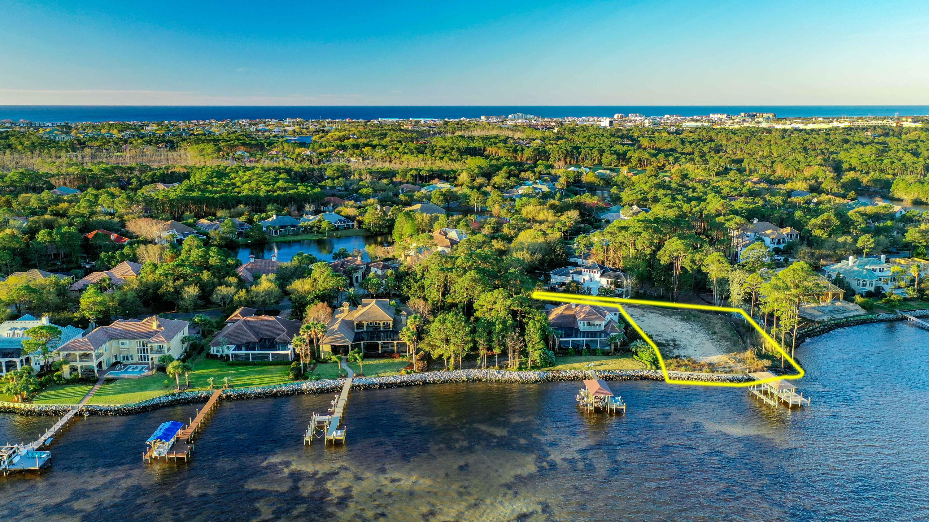WOW. STUNNING VIEWS FROM ALMOST EVERY ANGLE!! Perhaps the nicest Bay front lot in Destin w/146 feet on the water & situated further ''Out'' beyond the shoreline of the adjacent lots, this incredible .79 acre parcel will provide privacy & amazing Bay views from just about every angle . Ready to build on, this lot has been cleared, filled, surveyed PLUS attached is a letter from the county approving a larger buildable foot print. A newer constructed seawall & dock, with brand new boat lift w/superior constructed roof, allow you to enjoy the boating lifestyle & amazing views throughout the building process of your new home. Set back from street, this lot provides total privacy. Located in the exclusive, gated community of Regatta Bay, the community pool, tennis, renowned golf course, club house & restaurant are just a short golf cart ride away