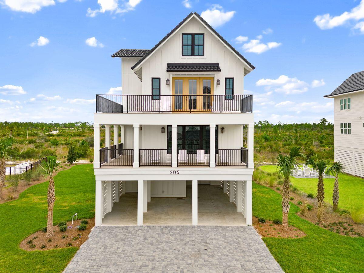 Introducing a striking four-level coastal haven that rises above Sugar Sand's quiet shoreline with style, comfort, and rare panoramic gulf views. Thoughtfully crafted in 2025 and fully furnished for an effortless arrival, this 3,477-sq.-ft. residence pairs modern architecture with refined coastal design to create an elevated retreat only steps from the beach.

Set on an X-flood-zone homesite with impressive third-tier gulf vistas, the home offers a layout designed for both privacy and connection. Multiple king suites span the second and third floors, each with walk-in closets, custom shelving, and serene ensuite baths. A bunk room on the upper level adds family-friendly flexibility, while a private elevator glides between all four floors for seamless movement. The main living level is airy and inviting, wrapped in soft coastal tones and anchored by an open chef's kitchen with quartz surfaces, a generous island, premium appliances, and abundant storage. Recessed lighting, crown molding, intentional detailing, and curated furnishings elevate every space, creating a refined atmosphere suited for extended stays or high-demand rental appeal.

At the top of the home, a coveted fourth-story viewing balcony delivers an unforgettable vantage point where sweeping gulf horizons and postcard sunsets feel close enough to touch. Morning coffee and evening wine both find their perfect moment here.

An expansive driveway and covered parking accommodate six or more vehicles, offering a rare level of convenience for beach living. Outside, the gated Sugar Sand community enhances the experience with quiet streets, deeded beach access points, and anticipated resort-style amenities, including a gulf-front clubhouse with pool and fitness center, boutique shopping, dining, and landscaped common areas.

Steps from the uncrowded shoreline of Mexico Beach and designed for comfort, longevity, and turnkey enjoyment, this remarkable coastal residence presents a rare chance to own a brand-new, fully furnished luxury home in one of the Forgotten Coast's most desirable settings.