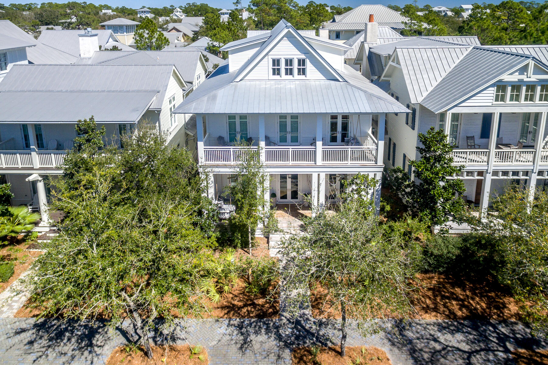Sitting on Hwy 30-A in phase 1 of Watercolor, this house is in a prime location only blocks away from the Watercolor beach club pools and beach access. With  over 5,600 square feet and a very open concept floor plan, this house is ideal for entertaining. The main house has 5 bedrooms and 5.5 baths which includes 2 spacious master suites, one of which has its own private balcony over looking the scenic 30-A. The carriage house has 1 bedroom, 1 bathroom, and its own living/ kitchen area. It also has its own washer/dryer closet. 
When you are not out enjoying one of watercolors several amenities, this house has the ideal outdoor living space! The back porch area has a private heated swimming pool, grilling area, and a gorgeous outdoor Fireplace. Or if you prefer to relax and enjoy the great weather, the 2 swinging beds on the front porch may be the spot for you. 
The house also has 2 full-size  garage spaces and parking in its driveways. 
 Watercolor's exceptional community amenities include several beautiful swimming pools, a gulf front beach club, nature trails, kayaking, canoeing, pickle ball, tennis, Camp WaterColor for kids which has a lazy river and multiple waterslide, parks and green spaces. Do not miss an opportunity to be part of this unique environment in an amazing house!
