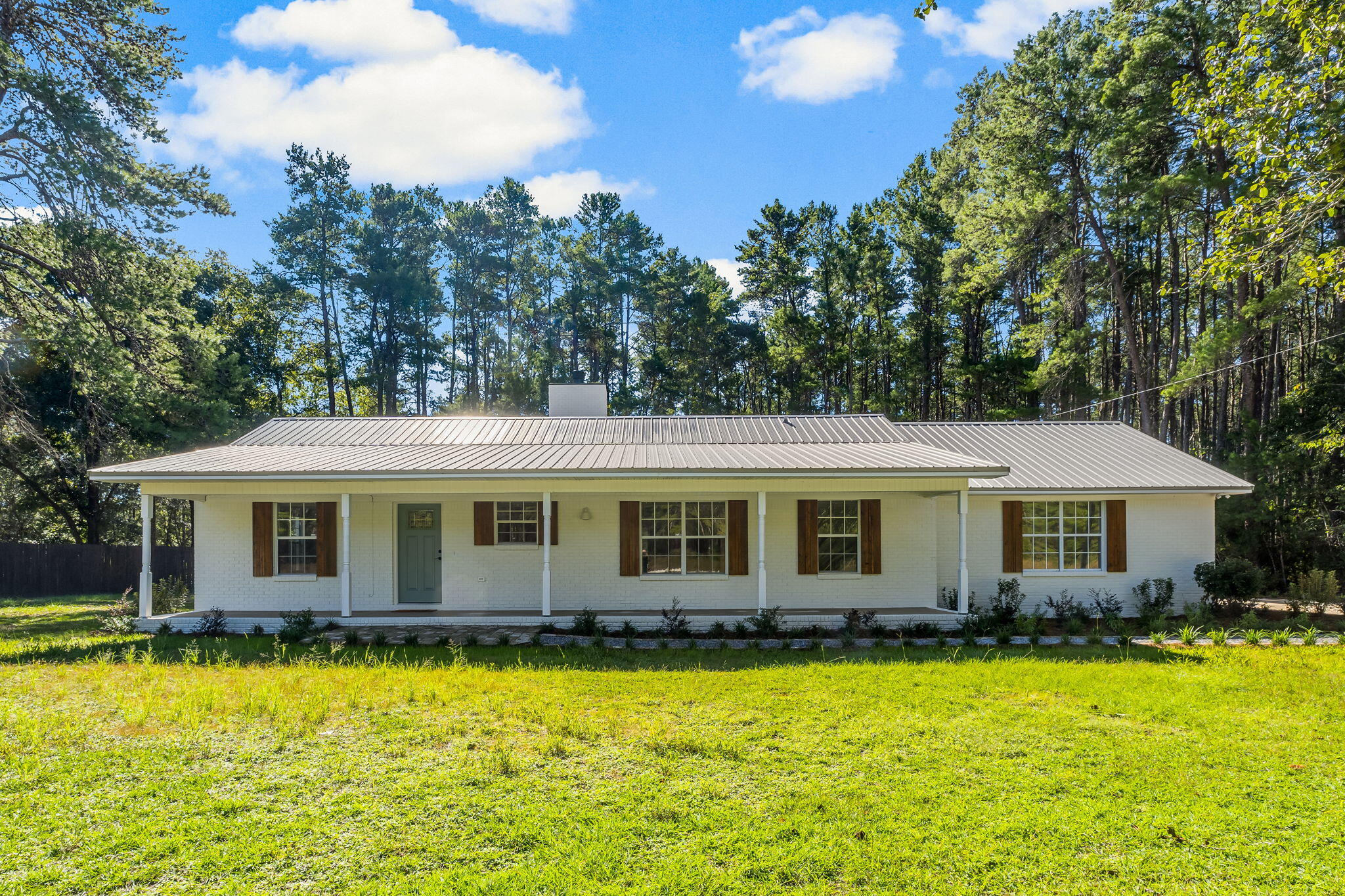 This fully remodeled ranch offers the perfect blend of modern living and rustic charm. Featuring luxury vinyl plank (LVP) flooring throughout, this home boasts three spacious bedrooms and three updated bathrooms. Enjoy cooking with all-new appliances in the fresh, contemporary kitchen. Kitchen opens up to cozy living room with wood-burning fireplace.
The property sits on a private, wooded lot with a partially fenced yard, ideal for outdoor gatherings.The yard is also a perfect area for additional parking for guests, extra vehicles, equipment, work trucks and vans, etc. Spacious front porch for sitting and catching sunset hues. No HOA restrictions, giving you the freedom to enjoy your home as you wish!
Located on HWY 3280 which is just 2 lights north of the 331 bridge. Easy drive to the beaches and happenings of South Walton and also the shopping centers and restaurants of Freeport.


The Beach Sunsets Inc. Resident Benefits Package is designed to provide convenience and professional services to our residents. By applying, Resident(s) agree to be auto-enrolled in the program and pay an additional $25.00 each month, payable with rent. Benefits of this package may vary due to the property specifications. No discount will be given if an element of the package is not available. The cost of this package is all-inclusive.