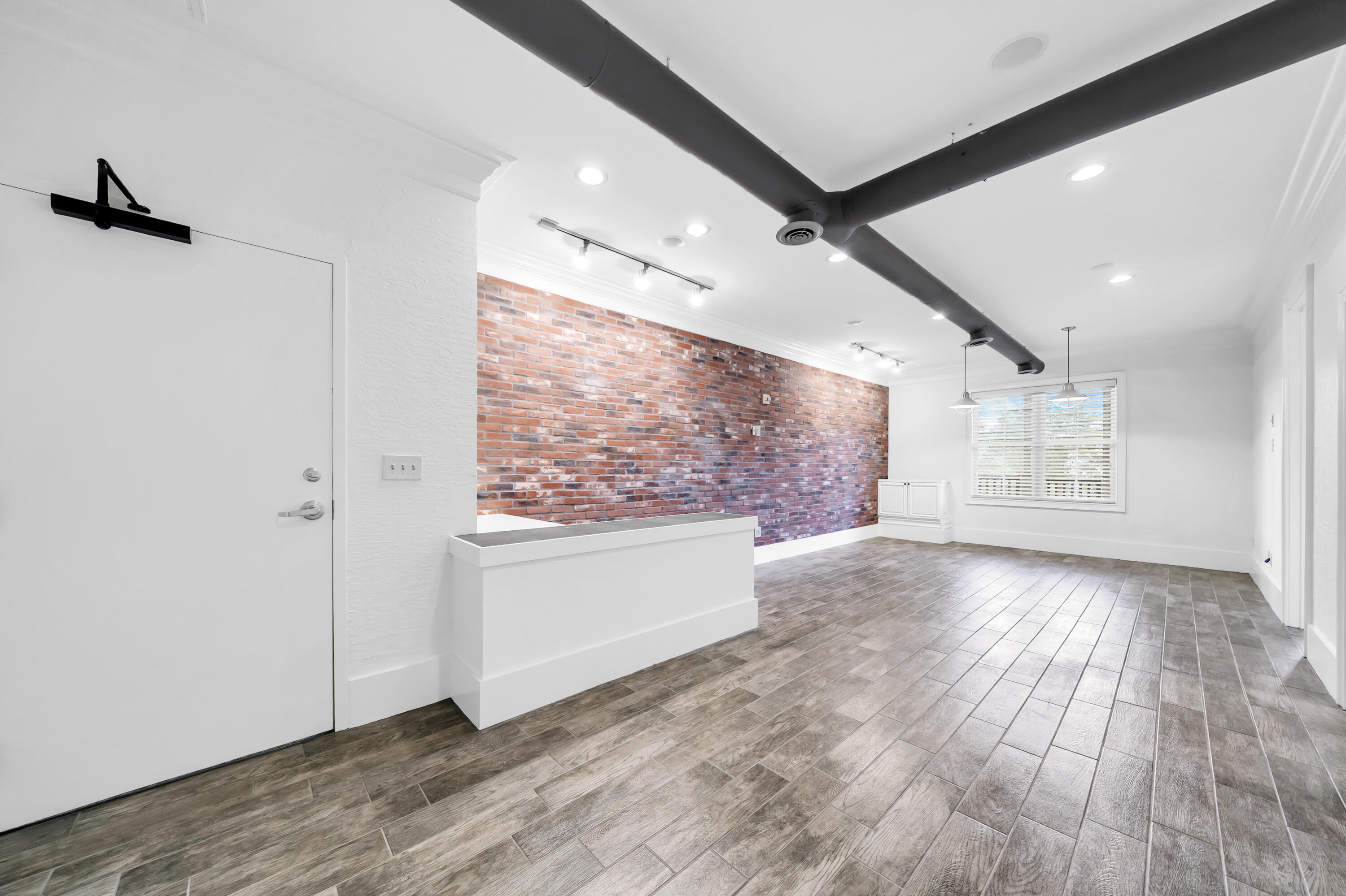 Prime Commercial Office Space for lease on Scenic 30A!  Strategically located in Redfish Village, enter from a heated/cooled hallway into open space with reception counter, brick accent wall, windows and natural light.  This 718 sq ft unit includes 2 private offices, tile/hardwood flooring throughout (no carpet), kitchenette, and one of the only private restrooms in this complex.  Exceptional location with established businesses including on-site restaurant (Redfish Taco), coffee/donuts/ice cream across the street (Blue Mountain Creamery) and close proximity to the beach.  Gross lease, call today for details!