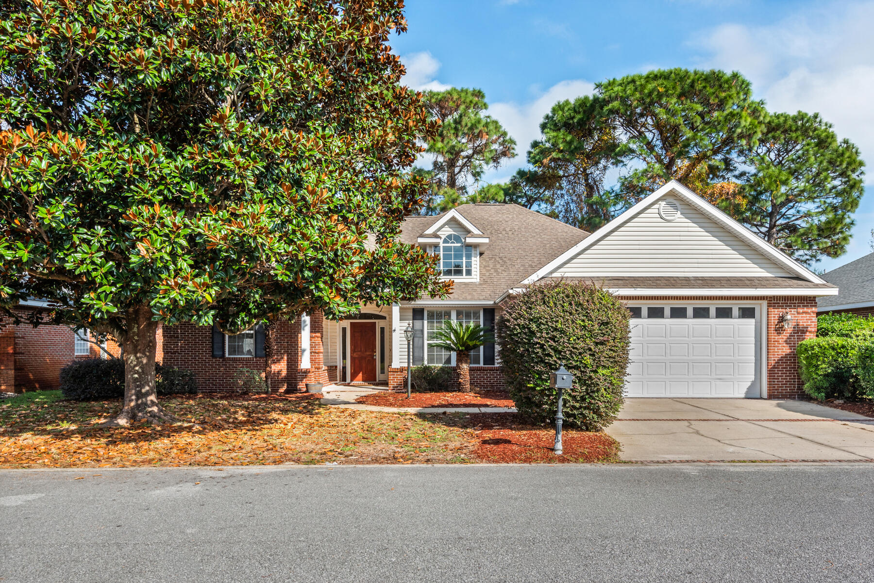 Turn-key, move-in ready single-story home in the gated Magnolia Plantation community of Bluewater Bay. With an open, efficient layout and a seamless flow between living spaces, the home offers a classic brick exterior with decorative details and attractive curb appeal. Inside, elegant architectural touches enhance the space, including a private primary suite with a tray ceiling, direct access to a screened rear porch, and a large walk-in closet. The primary bath features cultured-marble finishes, a double vanity, a whirlpool tub, and a glass shower. Two additional bedrooms share a well-appointed hall bath. The outdoor screened porch provides a relaxing spot for entertaining. Located with convenient access to nearby military bases and local amenities.